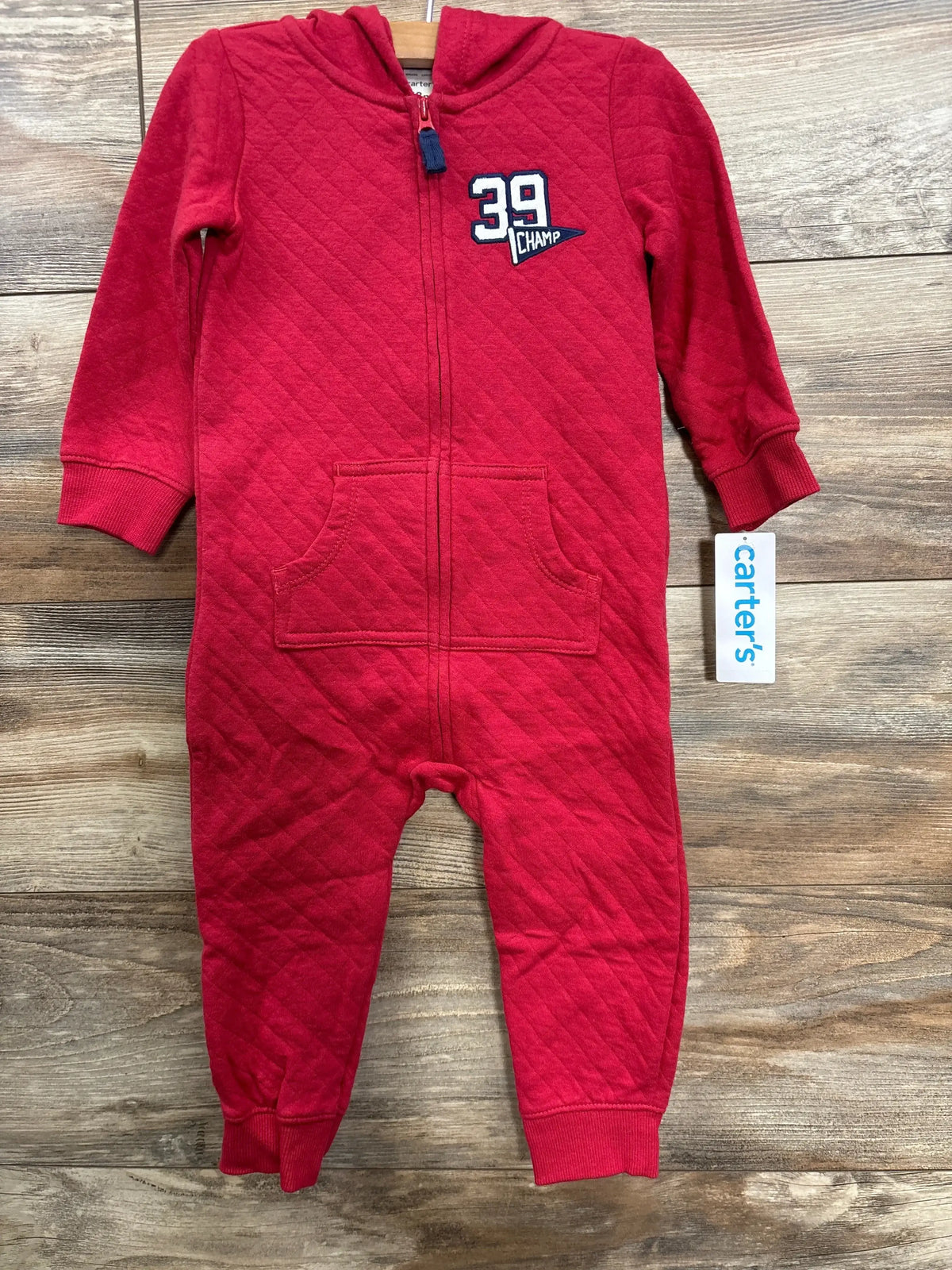 Red quilted baby onesie with hood, front zipper, and patch reading '39 Champ' on chest