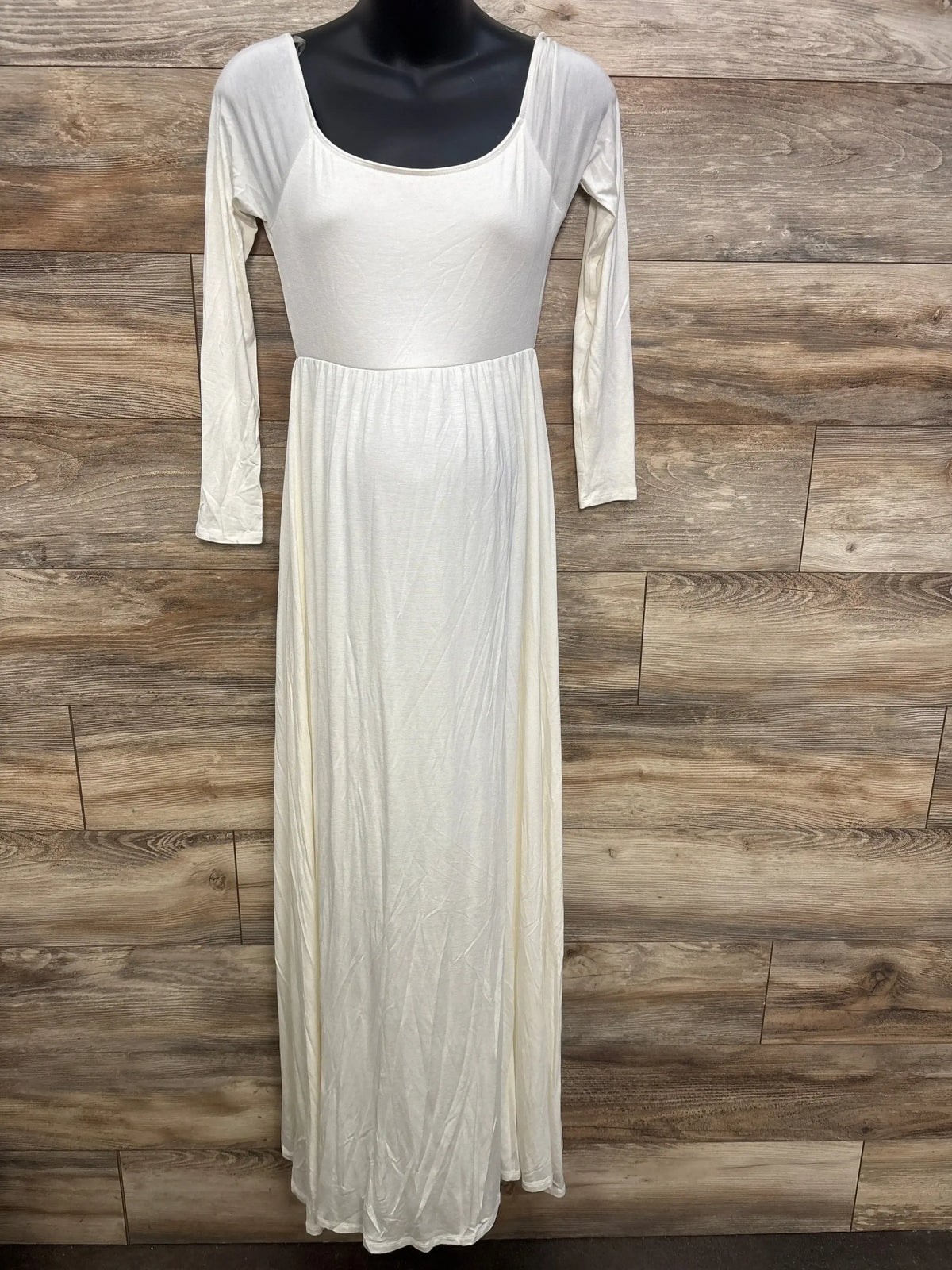 Ivory long sleeve maternity maxi dress with scoop neckline on mannequin