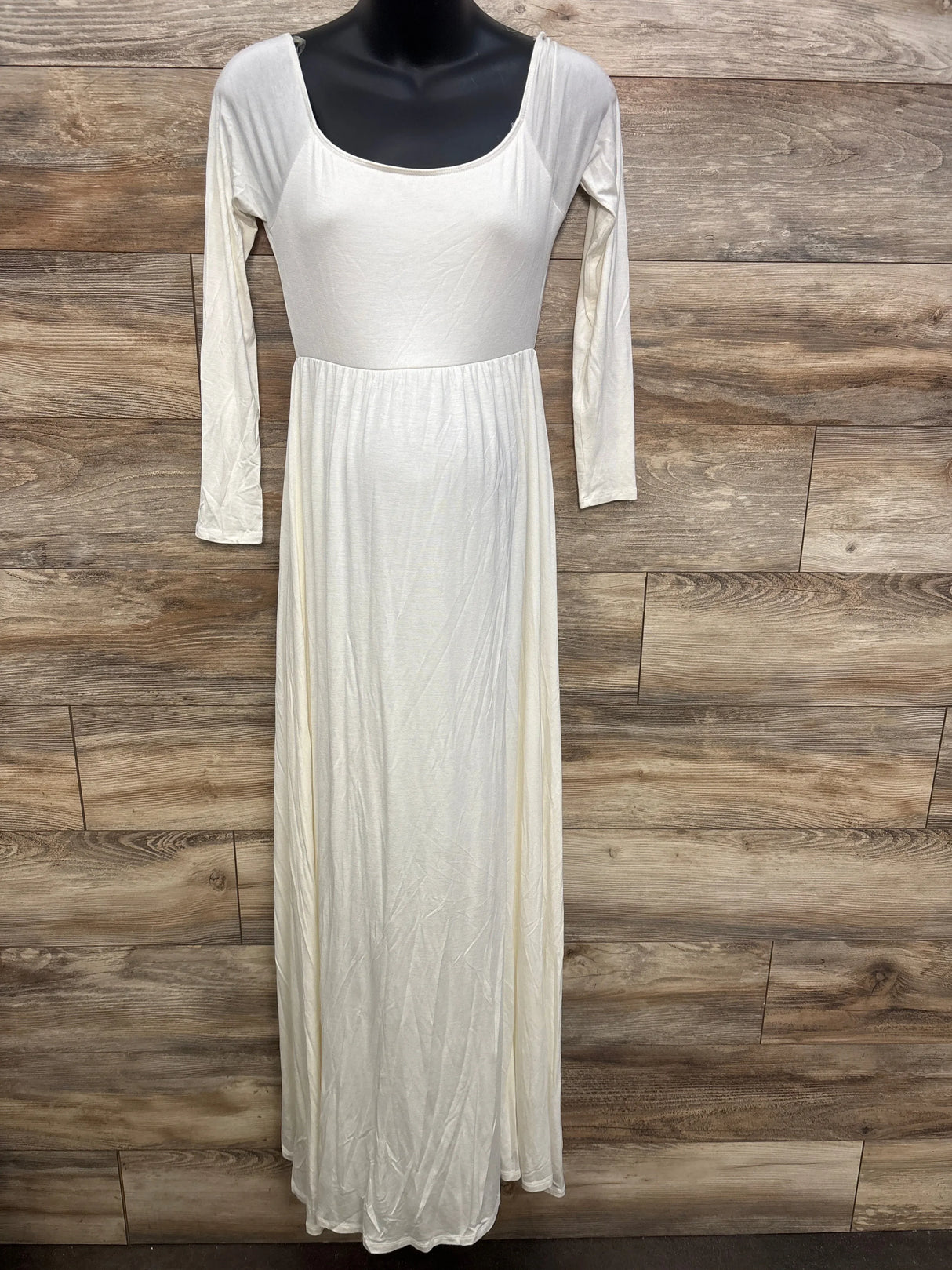 Ivory long sleeve maternity maxi dress with scoop neckline on mannequin