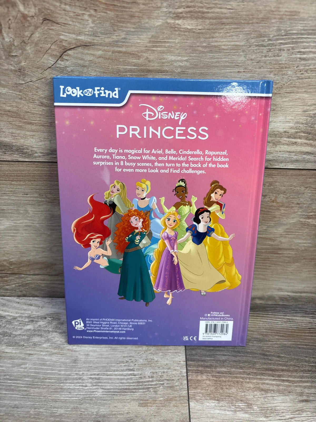 Back cover of Disney Princess Find the Magic hardcover book with eight princesses and hidden object challenges on a wood surface