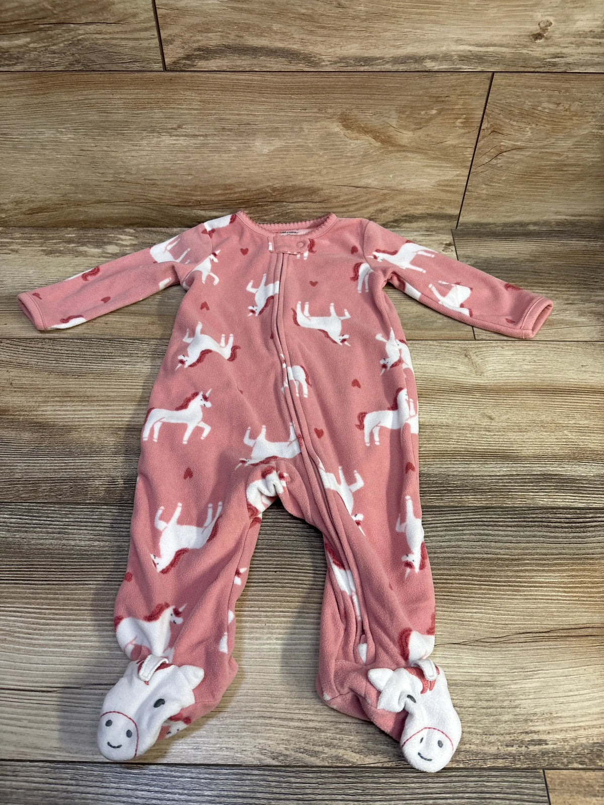 Front view of Child Of Mine pink blanket sleeper, size 3 to 6 months, showcasing unicorn print and footed design on wood floor