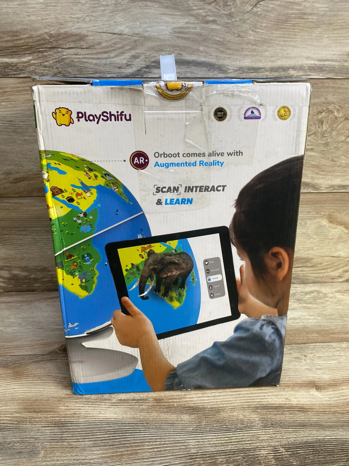 Front of PlayShifu Orboot Earth AR globe box with headline Orboot comes alive with Augmented Reality on wood background