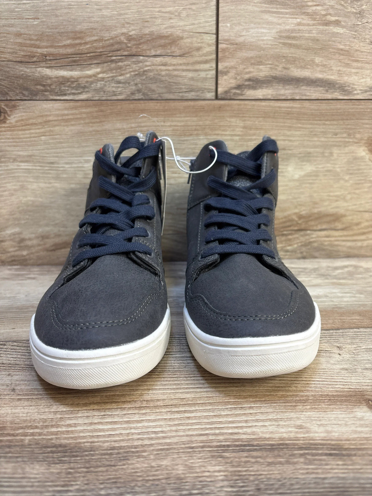 Front view of Art Class Geoff high-top kids sneakers, size 6Y, grey with navy laces and white rubber soles on wood floor