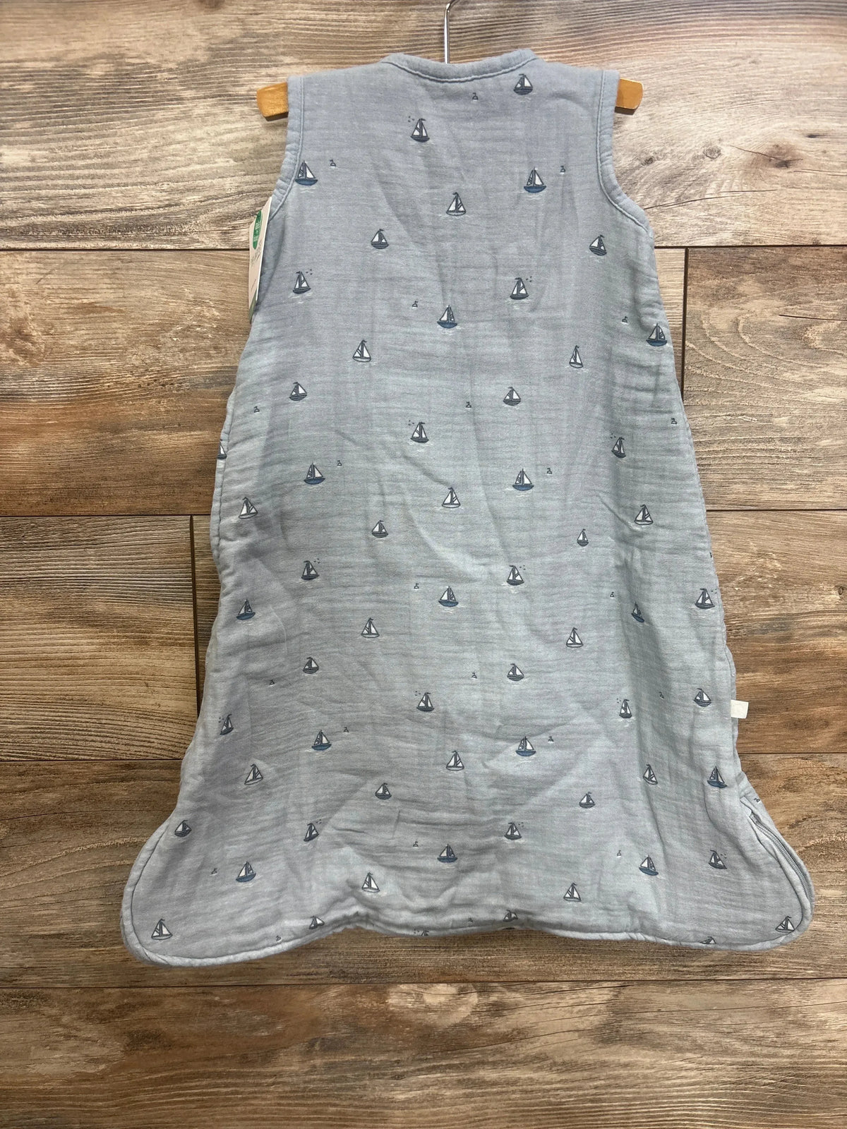 Front view of Little Planet gauze sleepbag size S 0-6m light blue with sailboat print, side zipper on wood floor