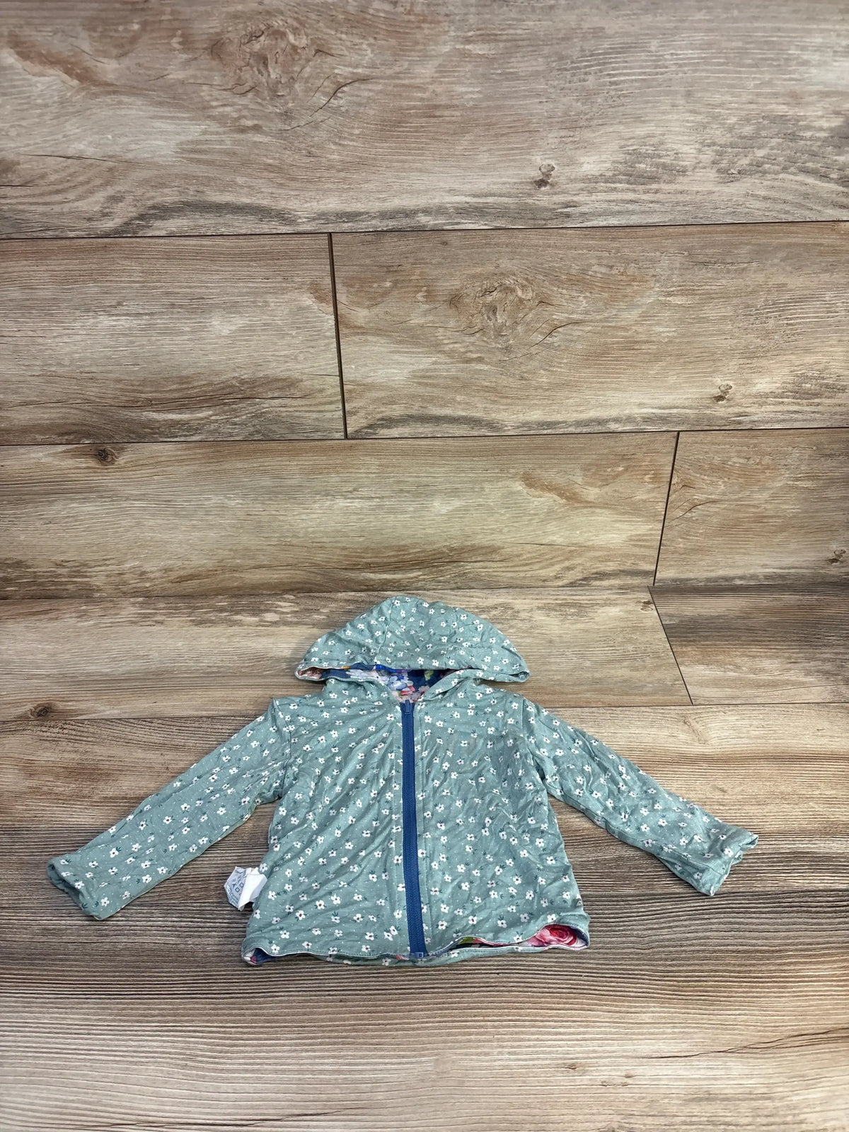 Front view of Posh P reversible baby hoodie showcasing hood and zipper on white background