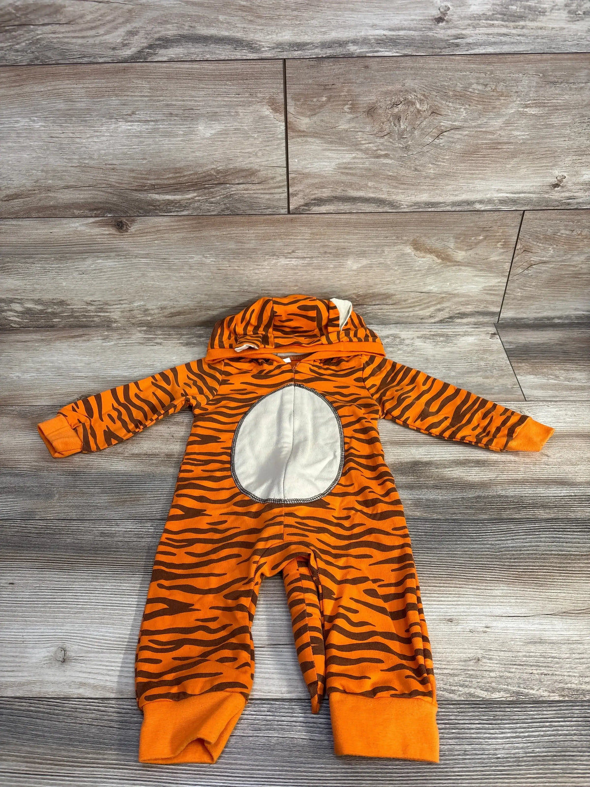 Orange tiger stripe baby onesie with hood and white belly patch, perfect for infant costumes or playful wear.