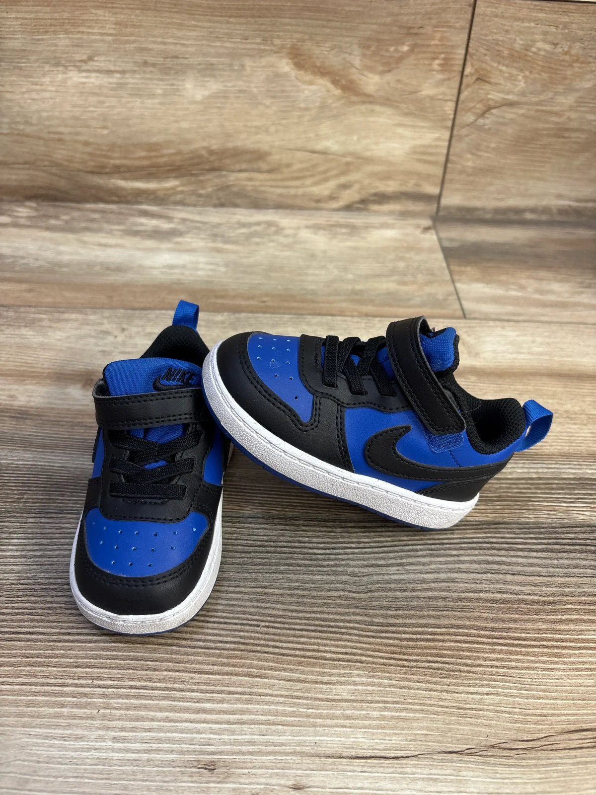Angled view of Nike Court Borough Recraft TD sneakers showcasing Game Royal and black panels with hook and loop closures