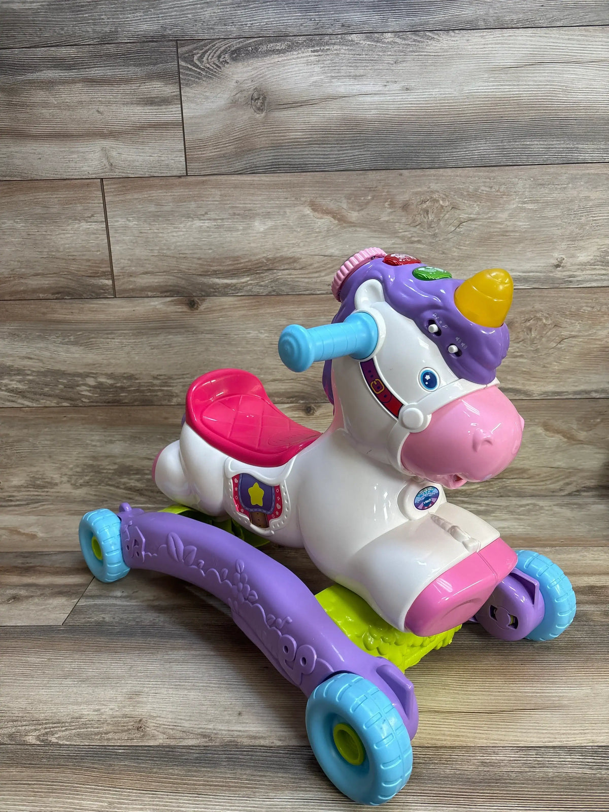 VTech Prance & Rock Learning Unicorn ride-on toy with colorful wheels and interactive buttons for toddlers