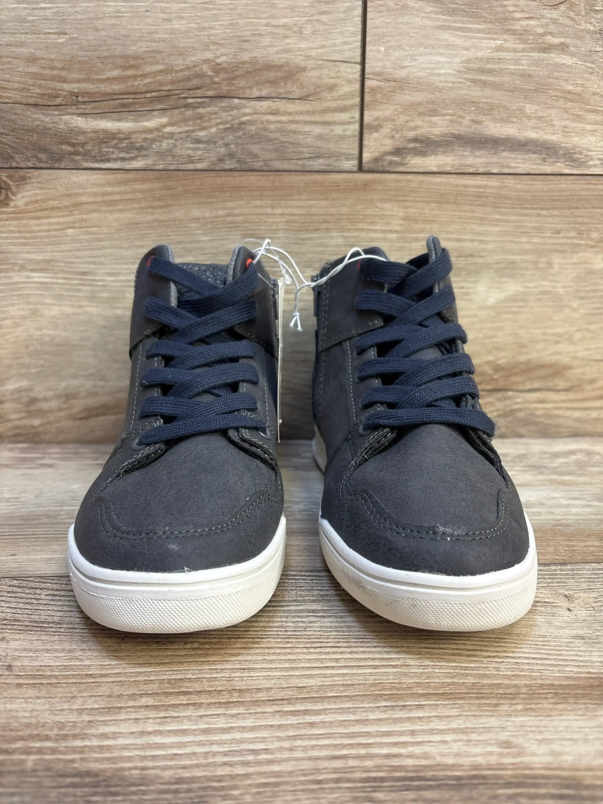Front view of Art Class Geoff high-top sneakers in grey, size 4Y, showcasing navy laces and white rubber soles on wood floor