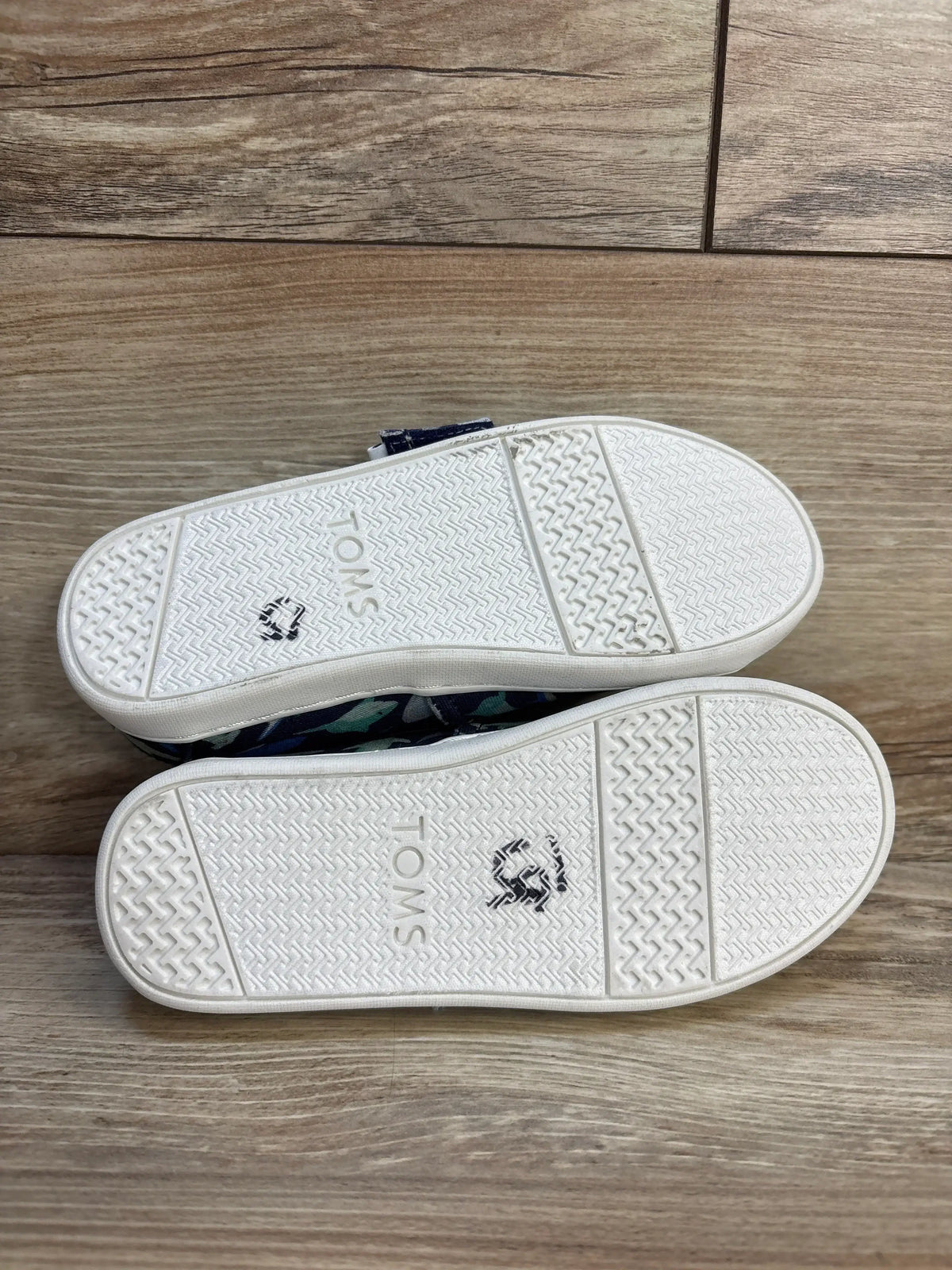 TOMS kids shoes with white soles and navy shark print, perfect for little feet