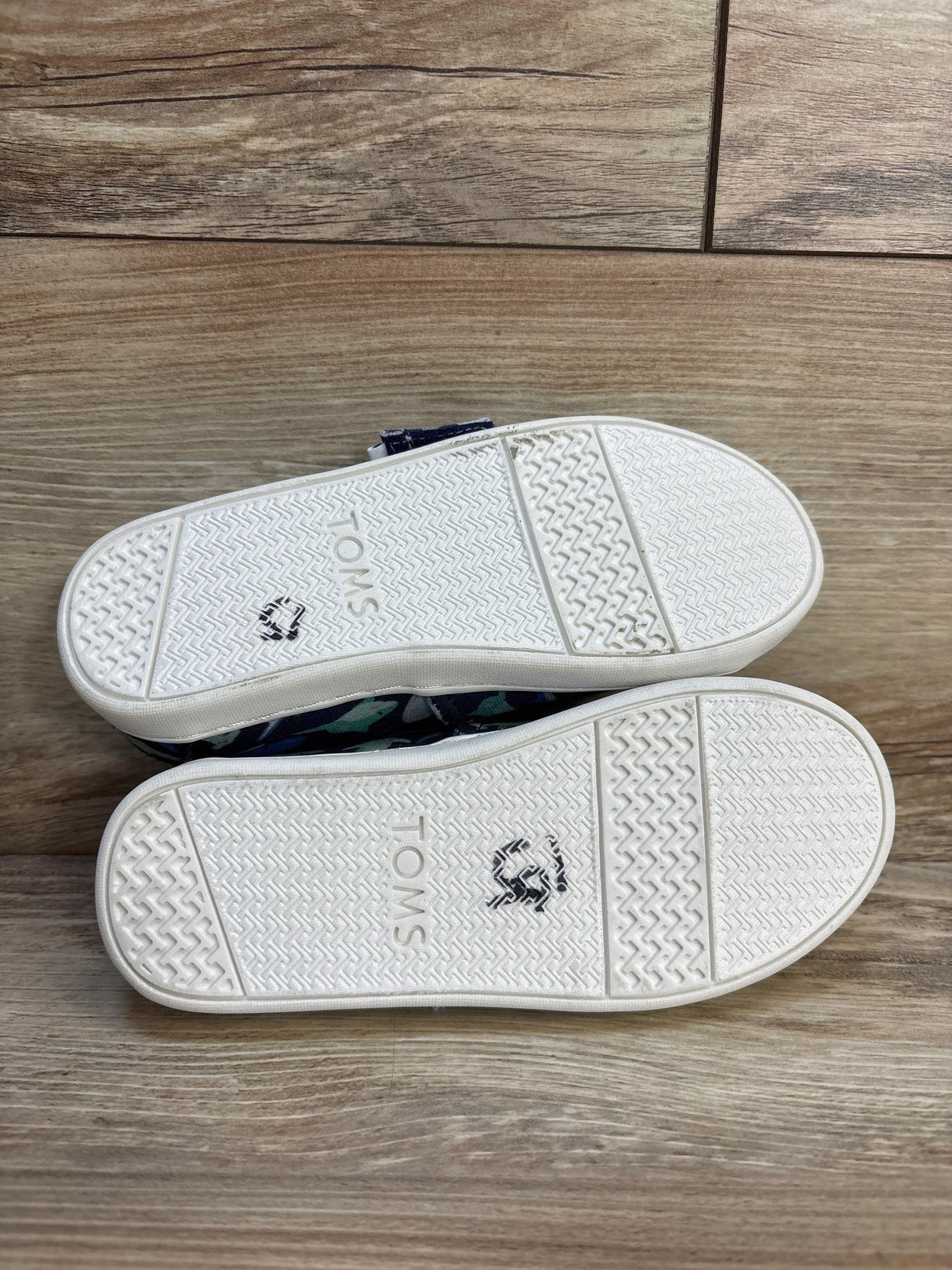 TOMS kids shoes with white soles and navy shark print, perfect for little feet