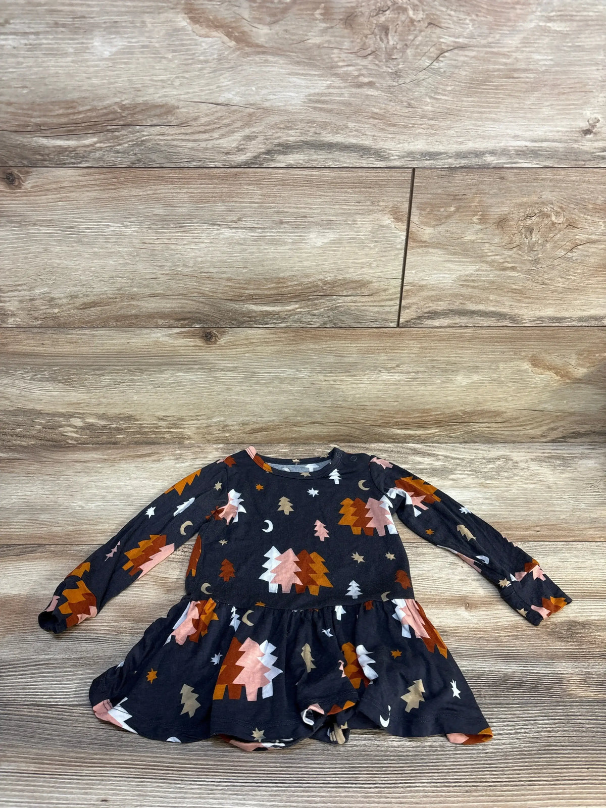 Flat lay of grey Luna tutu bodysuit with long sleeves, attached tutu skirt, and colorful tree and moon print