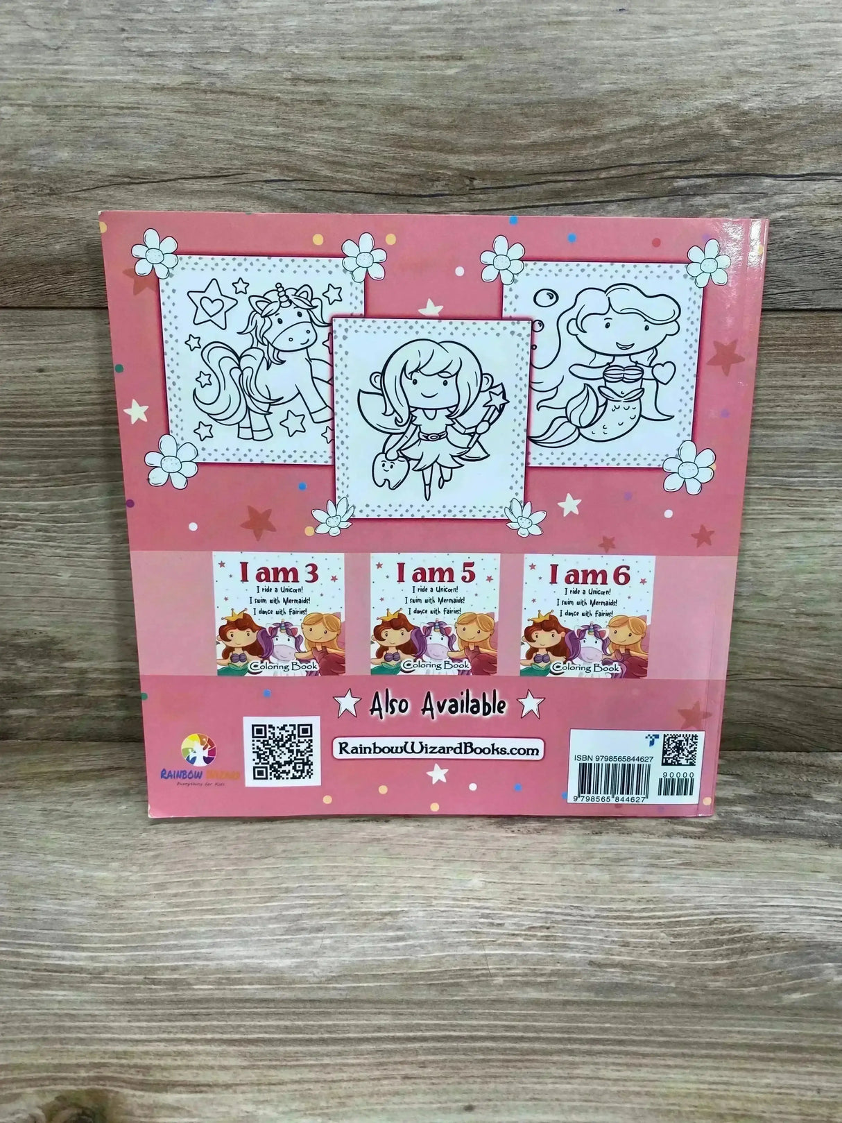 Back cover of I am 4 coloring book showing unicorn, fairy, mermaid line drawings, thumbnails, QR codes, and barcode on wood