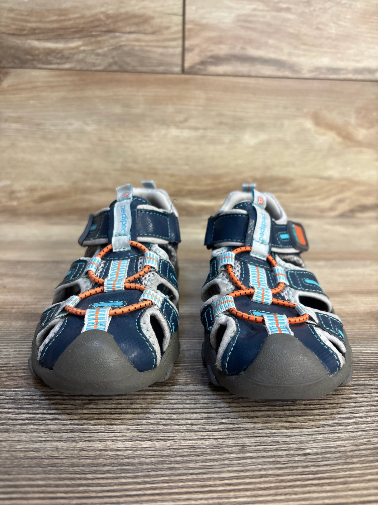Blue and orange toddler closed-toe sandals on wooden floor, kids summer shoes