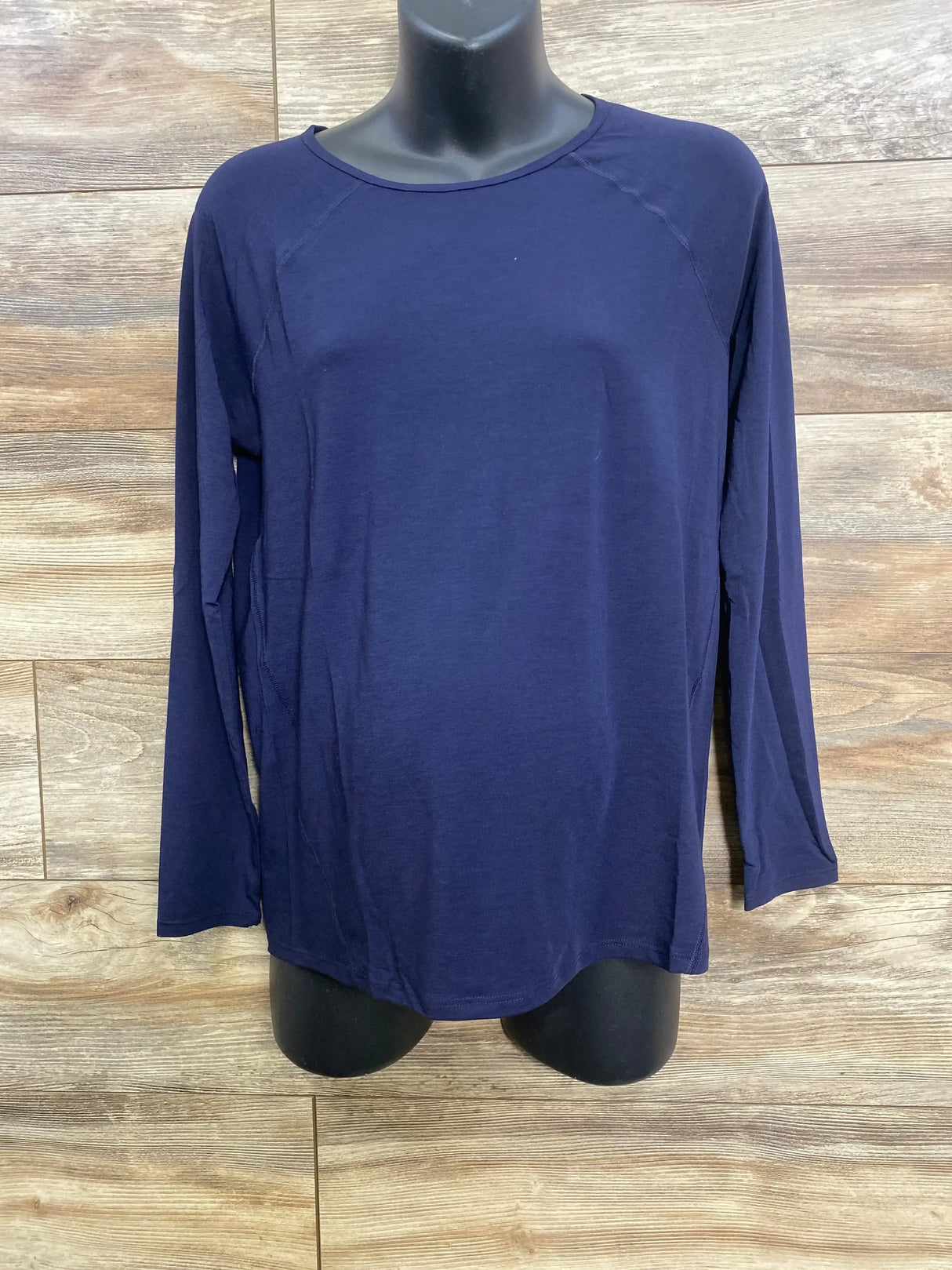 Front view of navy Gap maternity long-sleeve shirt with scoop neckline and relaxed fit on black torso mannequin