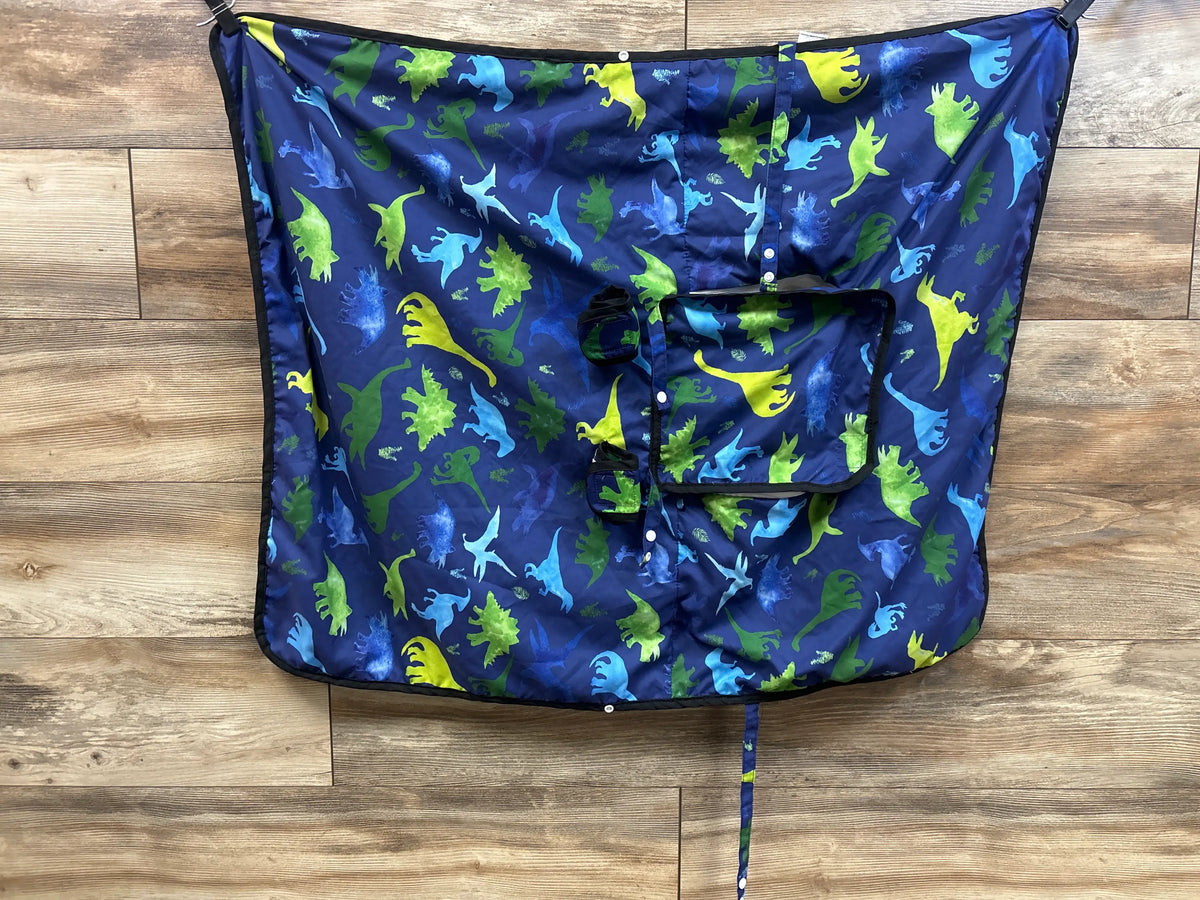 Front view of TANOFAR Minky Dinosaur Car Seat/Nursing Cover in navy with dinosaur pattern and nursing opening on wood floor