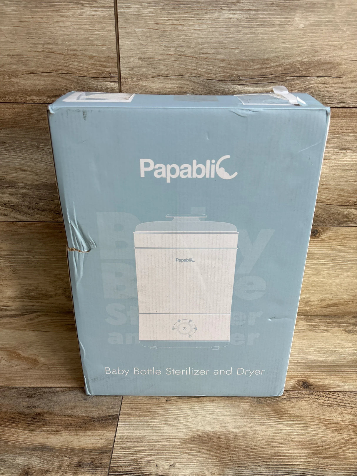 Papablic baby bottle sterilizer and dryer box on wood floor, light blue packaging