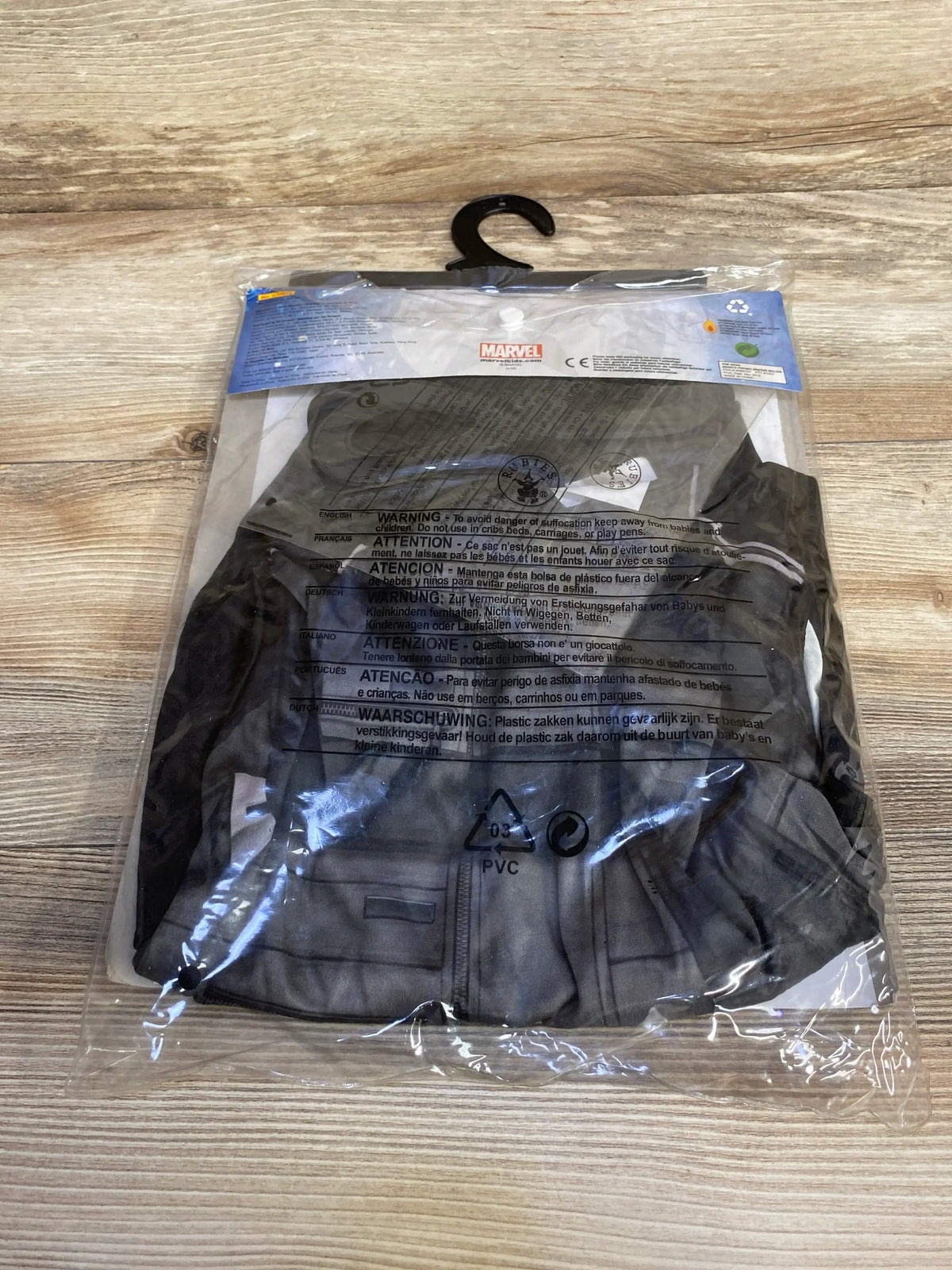 Front view of black Marvel Winter Solider costume in plastic packaging with a zippered jacket and chest pockets