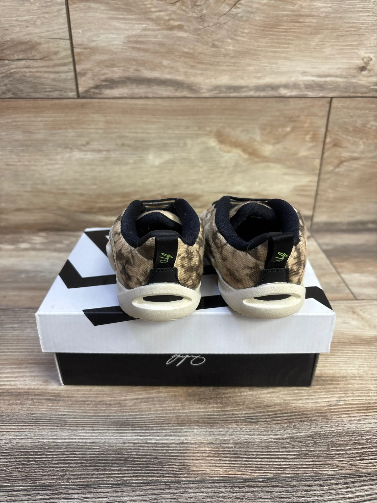 Rear view of Air Jordan Tatum 1 TD Tunnel Walk sneakers showcasing camouflage uppers and cream soles on a shoebox