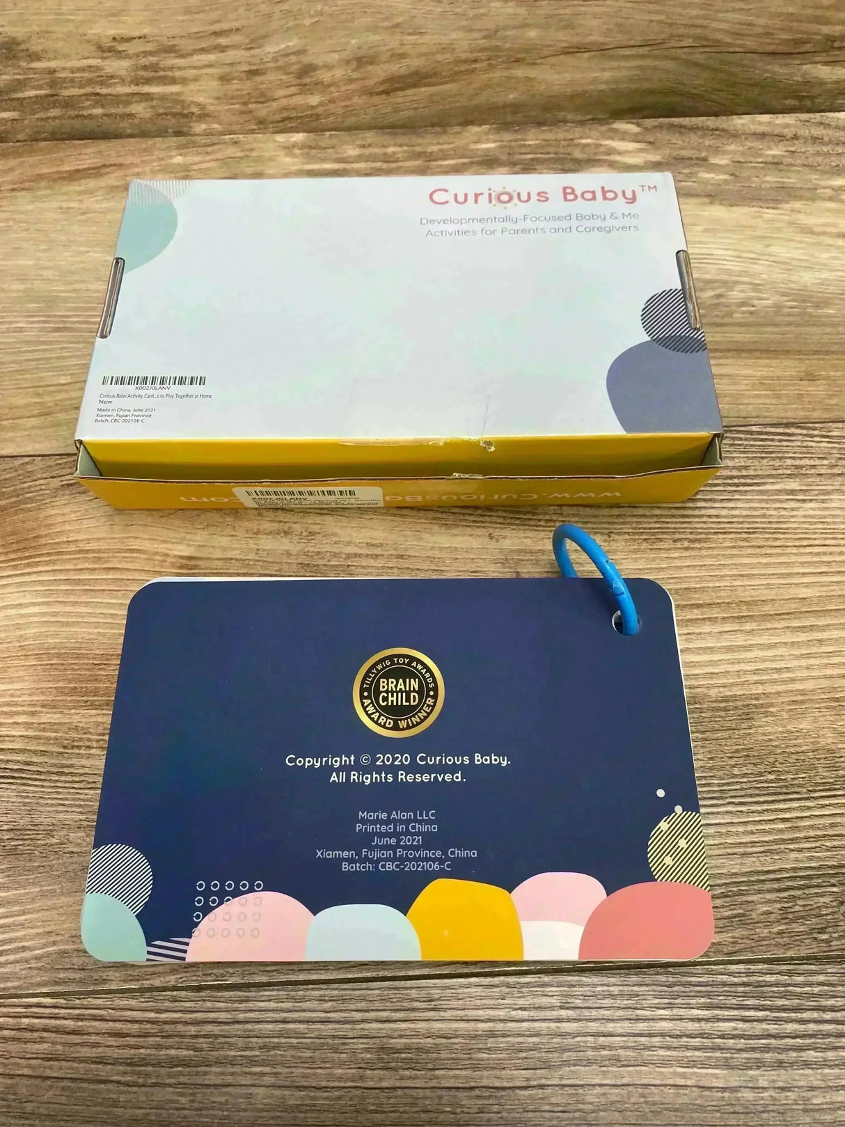 Front view of Curious Baby Activity Cards showing colorful illustrated cards fanned on white background