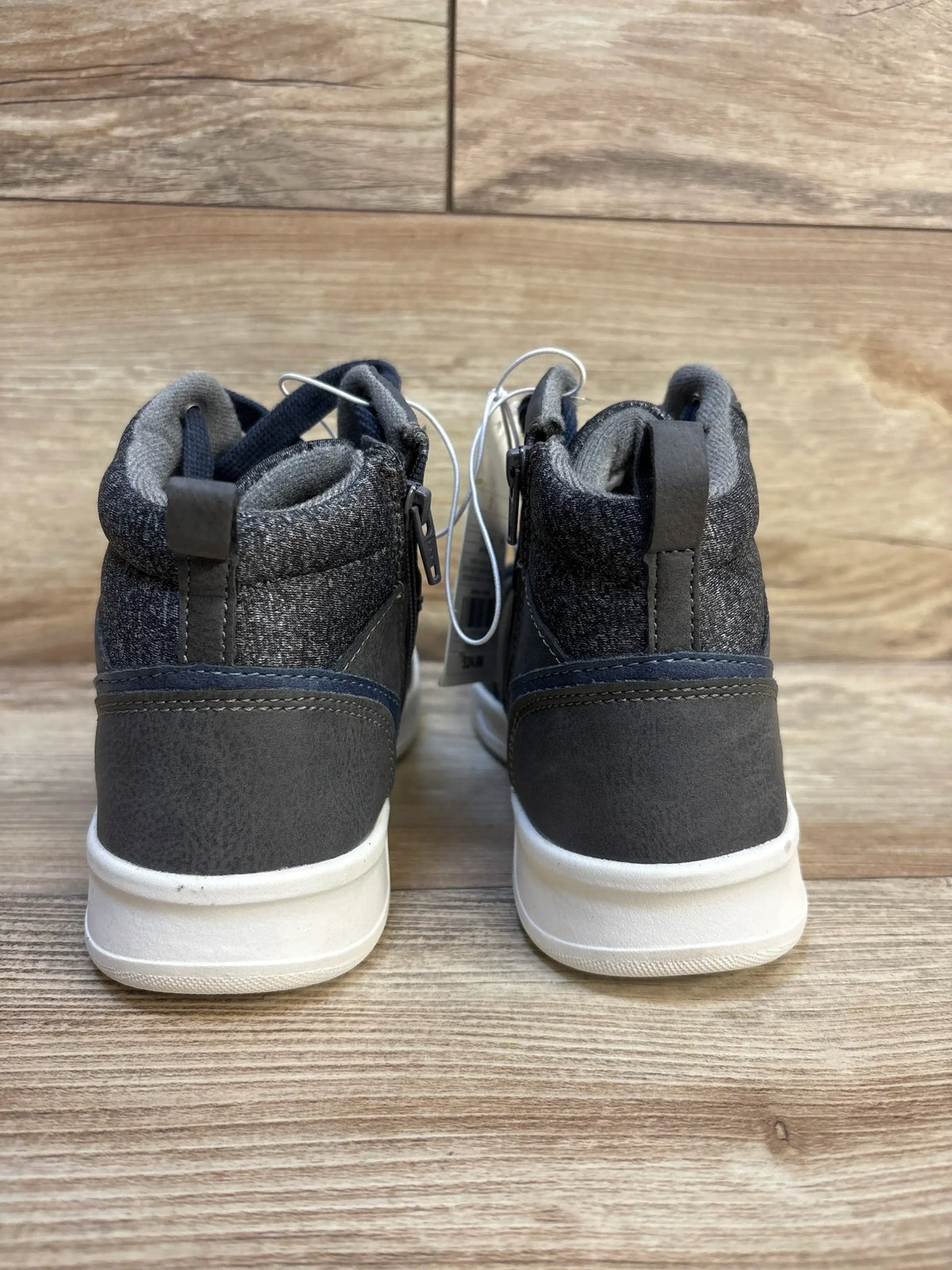Back view of gray children's high top sneakers on wood floor