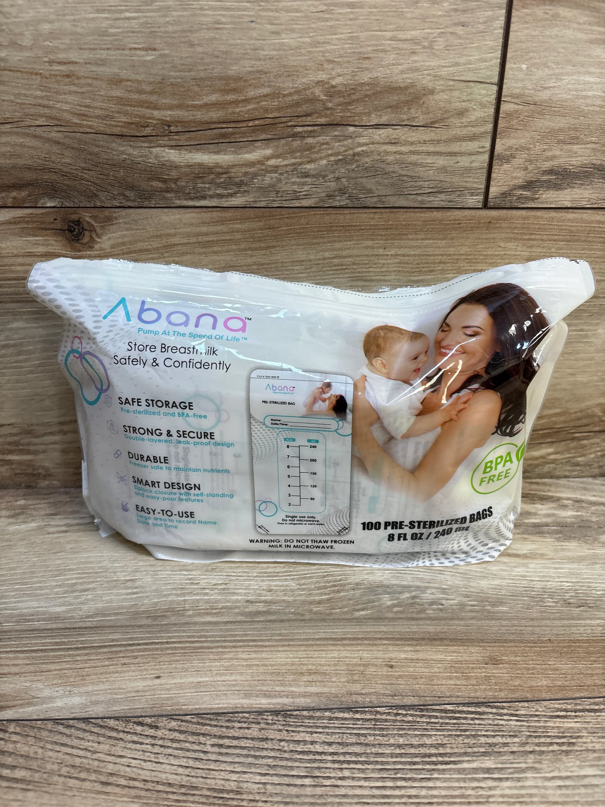 Front package of Abana breastmilk storage bags showing BPA free badge, measurement markings and 8 fl oz capacity on wood background