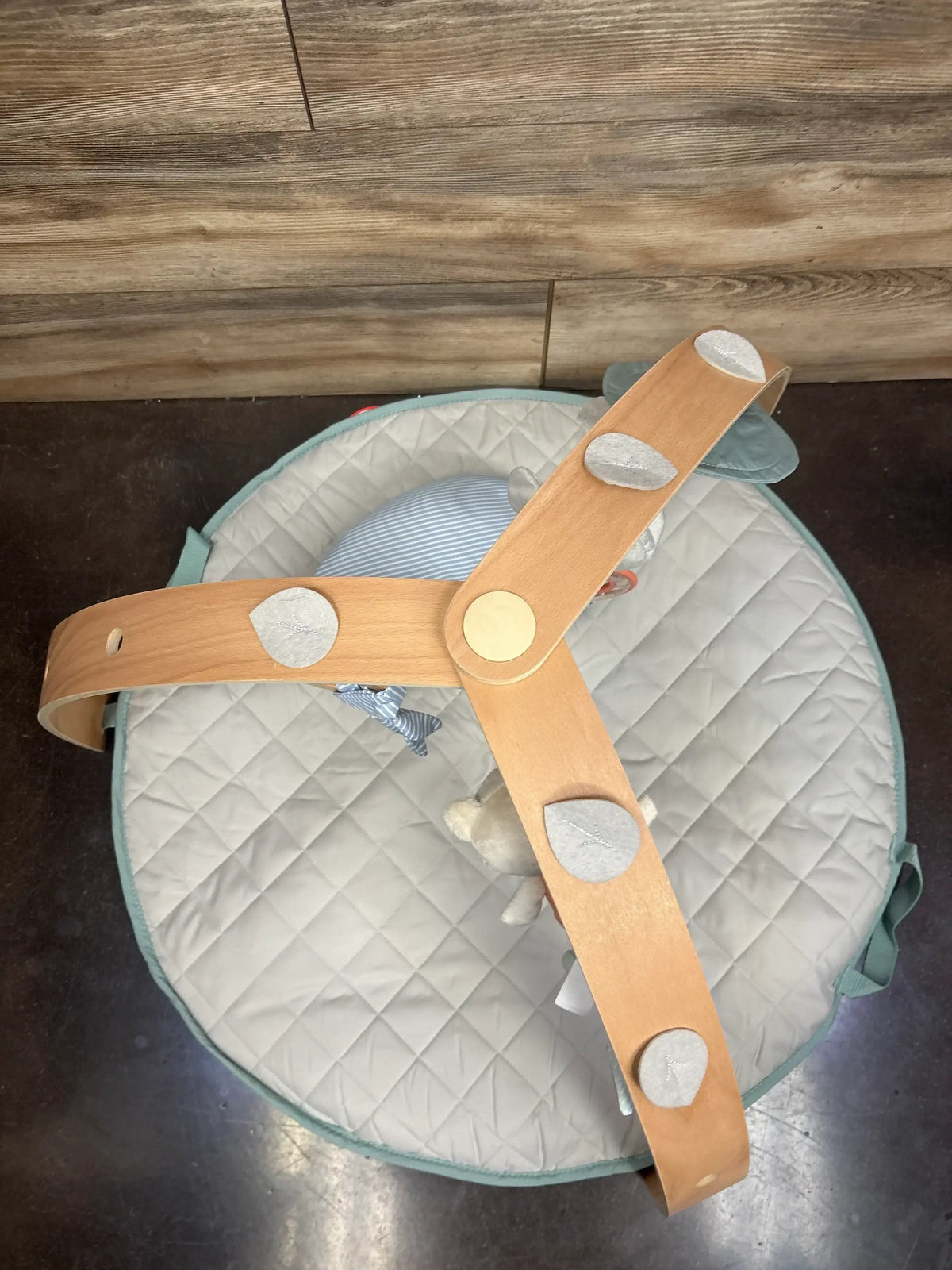 Quilted baby play mat with wooden arch and soft hanging toys for infants