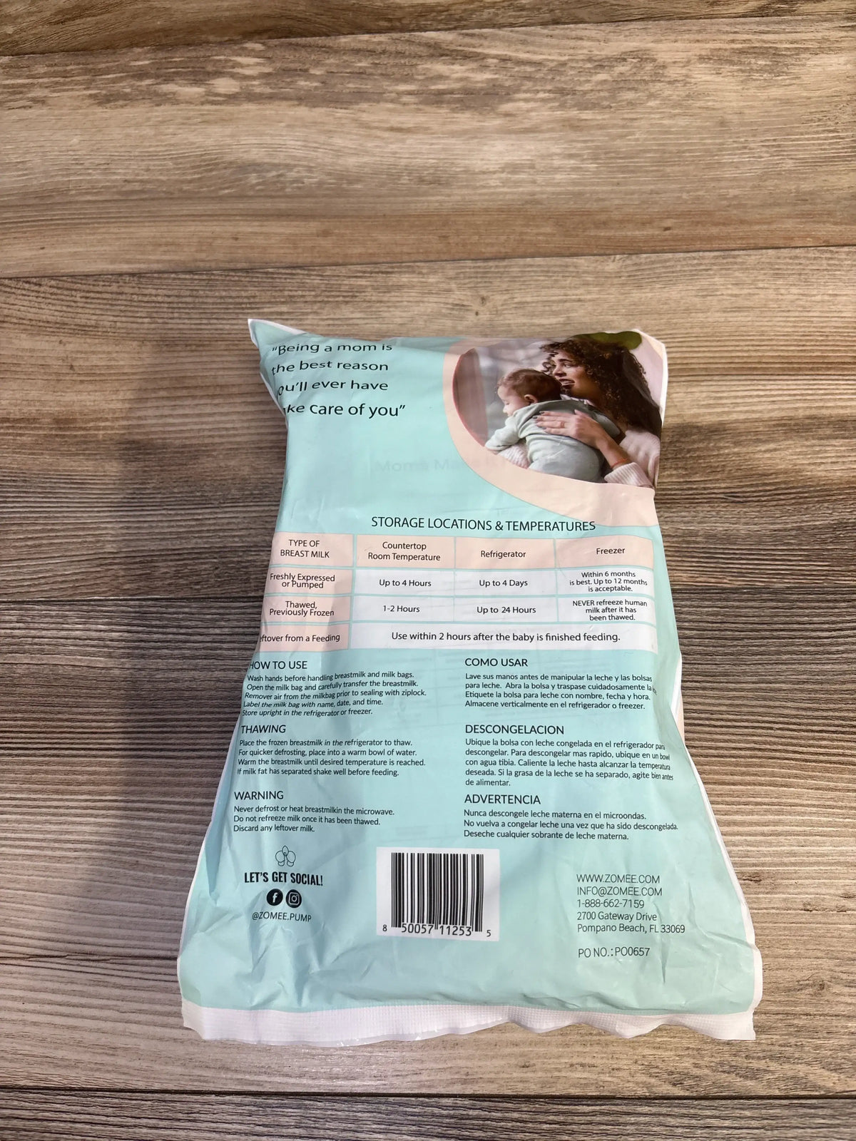Back of Zomee 8oz disposable breast milk storage bags showing storage table, instructions and barcode on wood surface