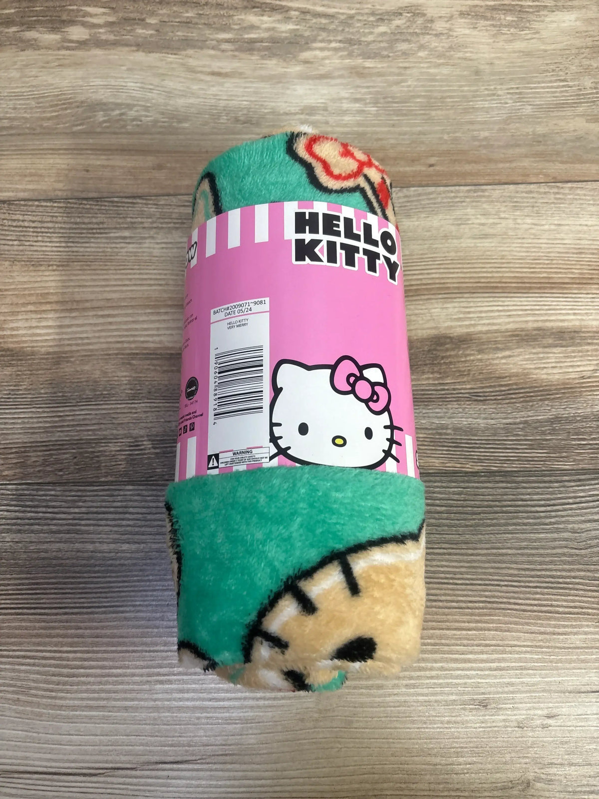Hello Kitty plush blanket with green and beige pattern, ideal for kids and baby gear