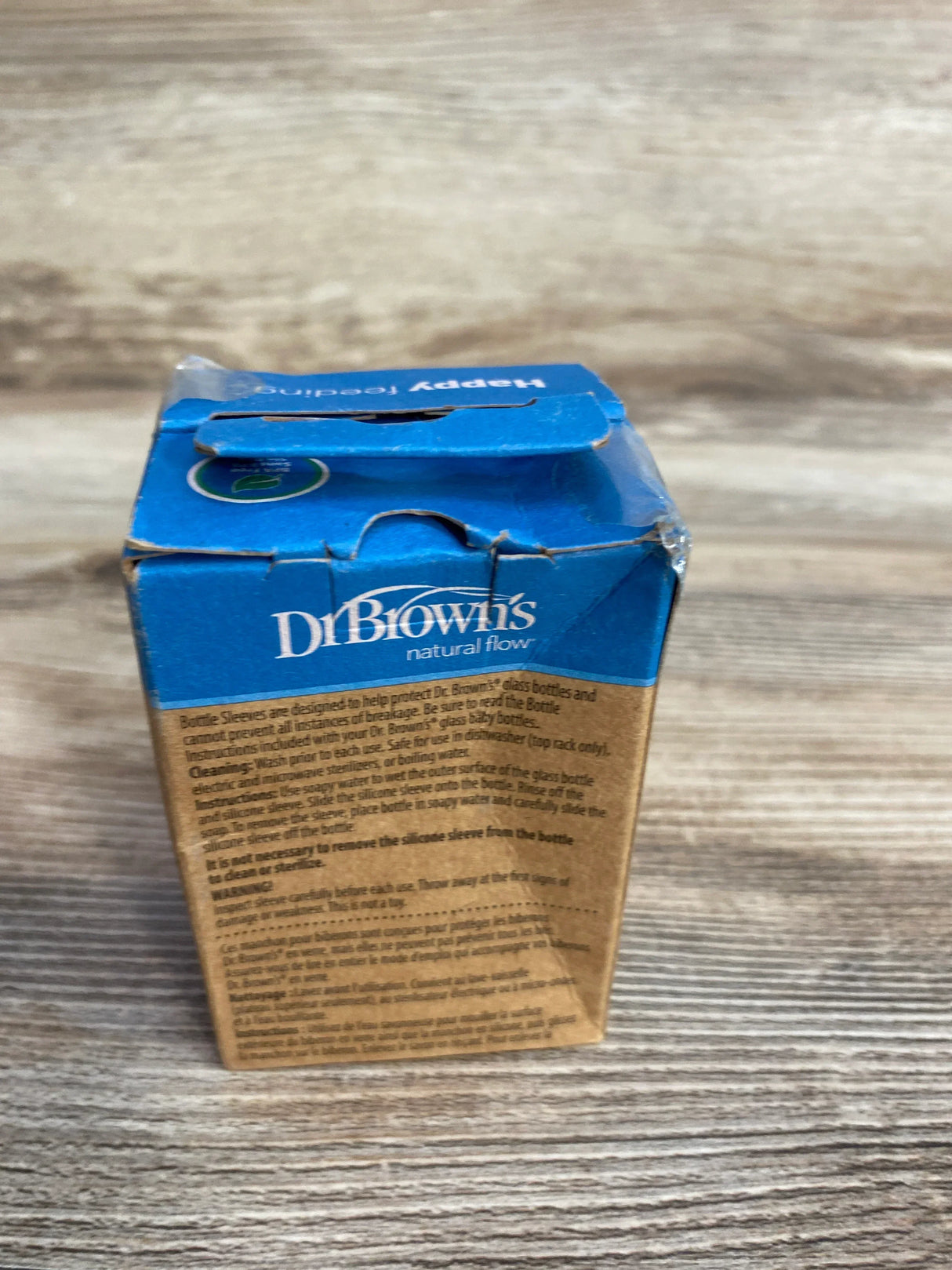 Dr. Brown's natural flow blue and brown bottle sleeve packaging on wood surface