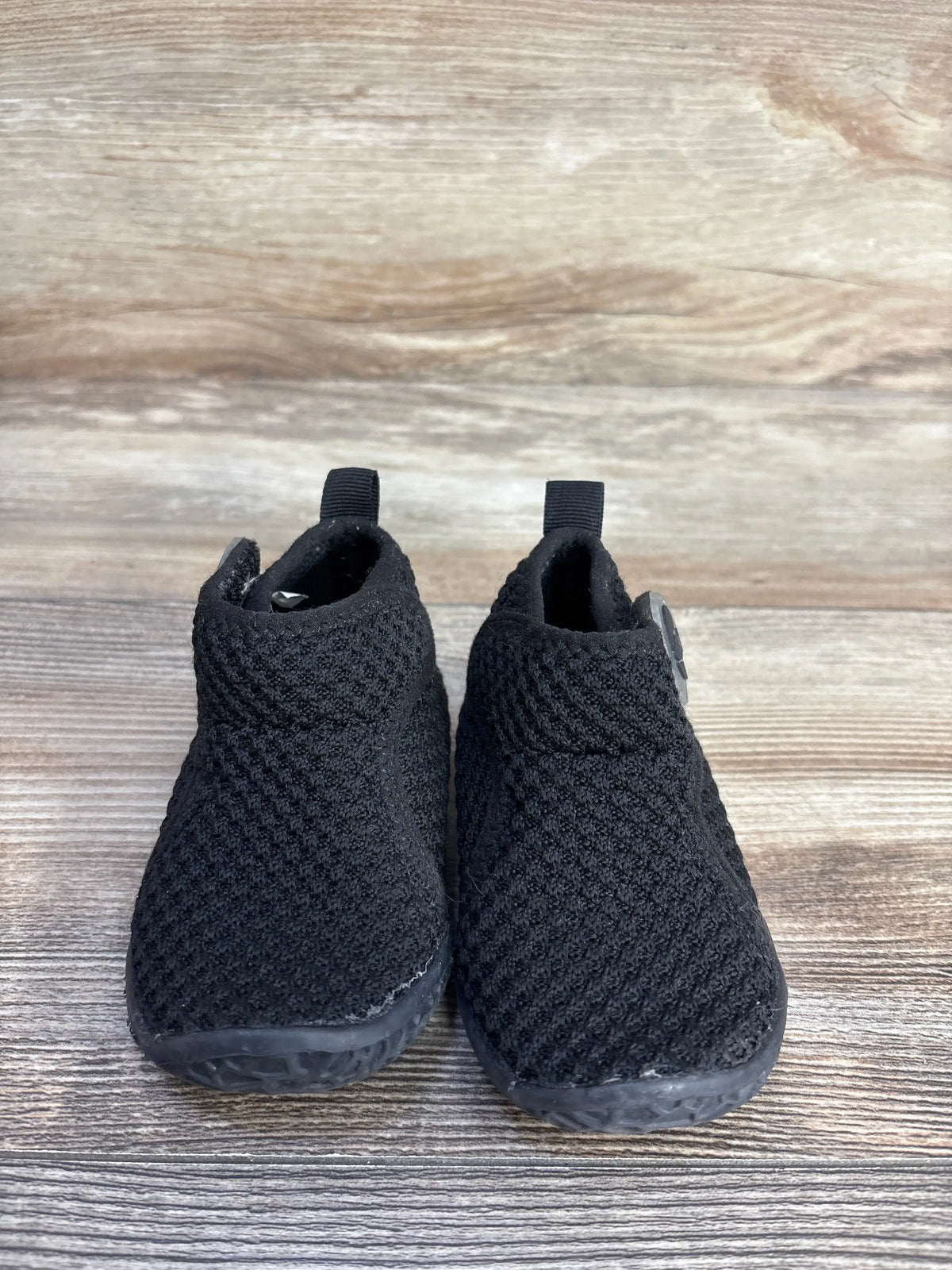 Pair of FEETCITY black high-top mesh sock shoes for toddlers on a wooden background.