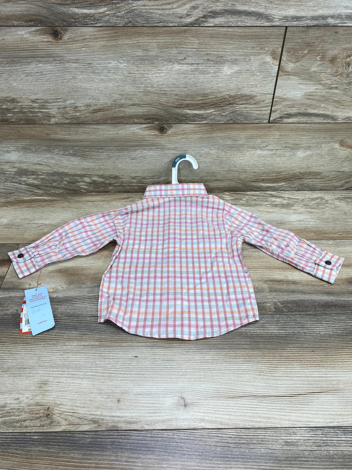 Back view of Cat and Jack plaid shirt, 18M, pink and orange, button cuff sleeves, tags, on white hanger over wood floor