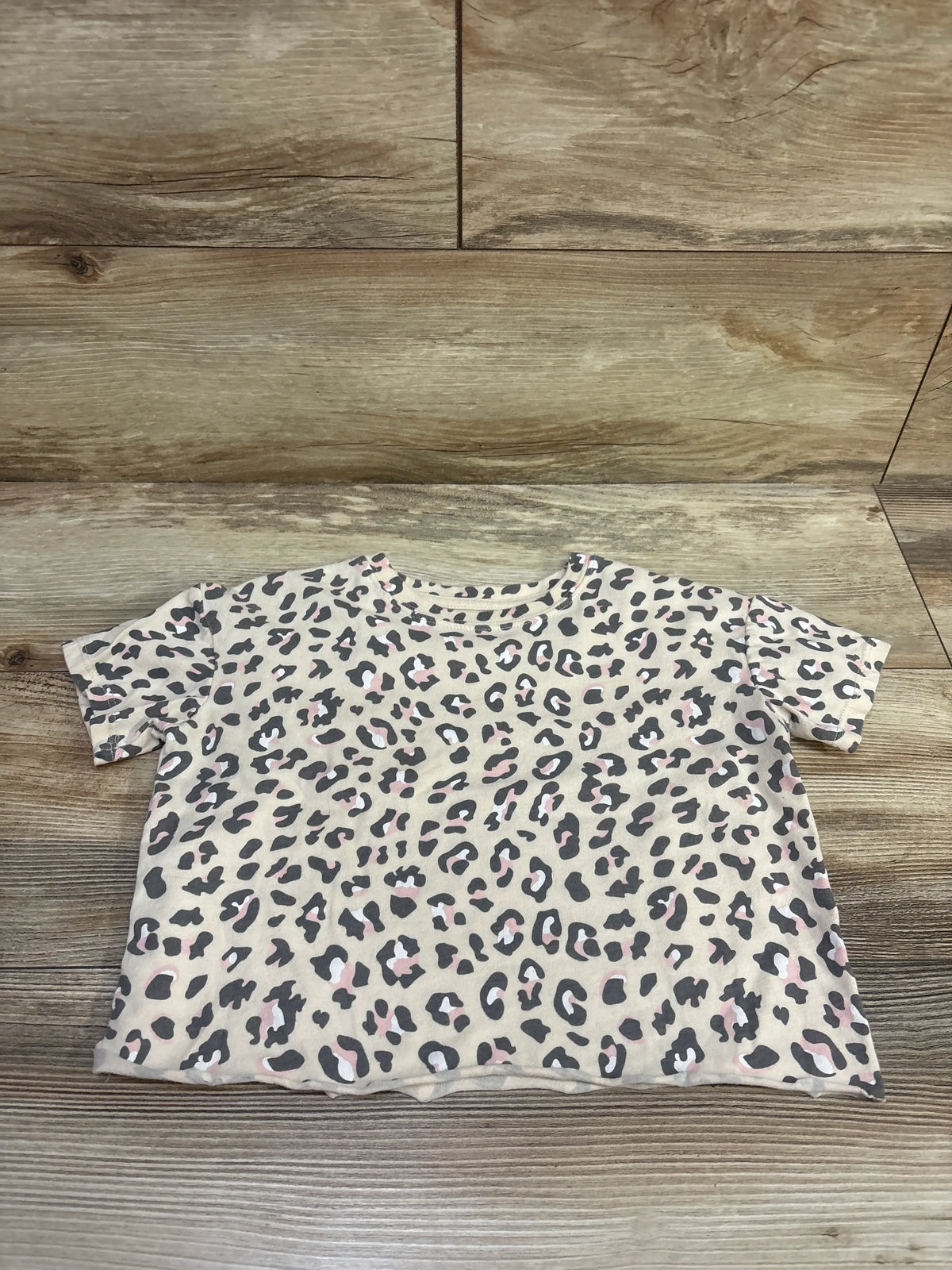 Front view of Grayson Mini Leopard Shirt in tan, size 5T, showcasing leopard print and short sleeves on a wood background