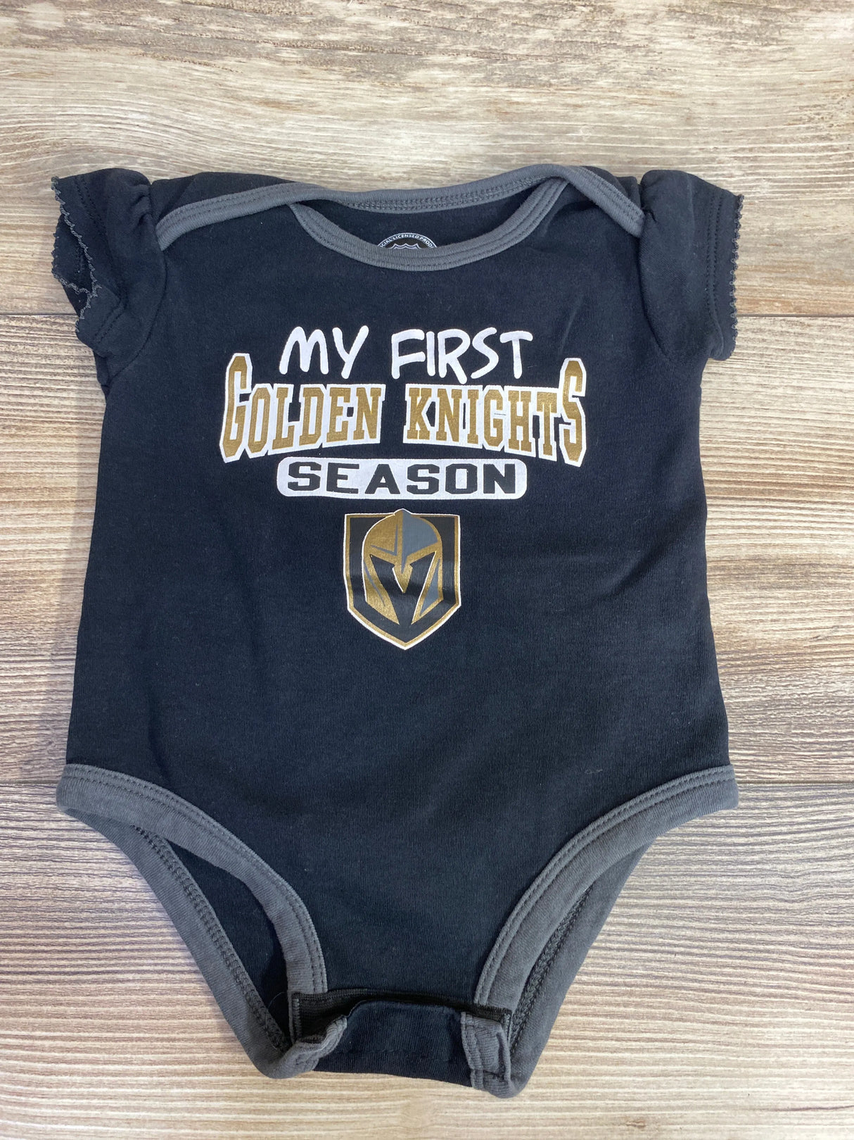 Black baby onesie with gray trim featuring Golden Knights logo and text My First Golden Knights Season