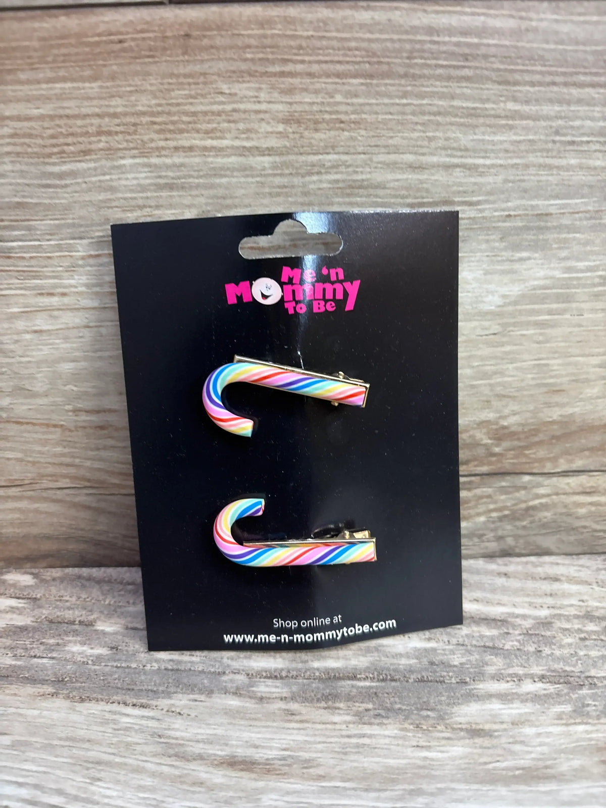 Rainbow candy cane hair clips for kids, colorful holiday accessories on black card