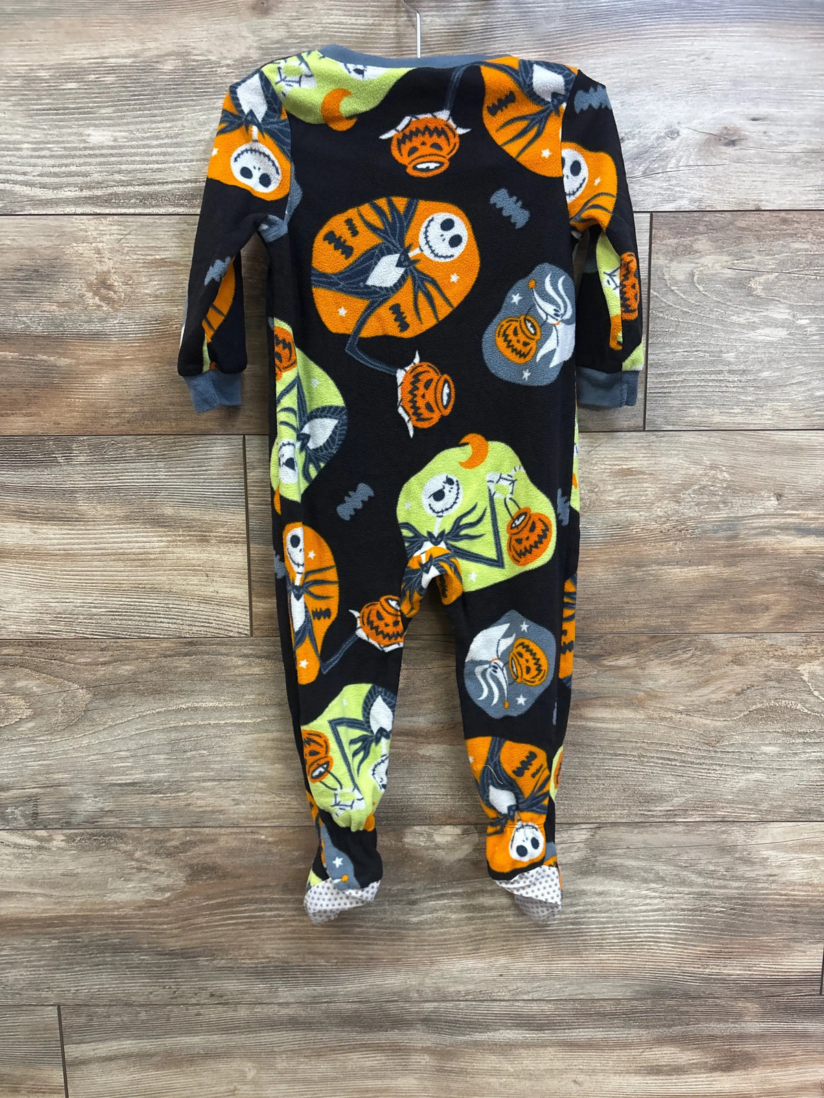 Back view of Nightmare Before Christmas fleece sleeper 2T with Jack Skellington pumpkin print on wood background