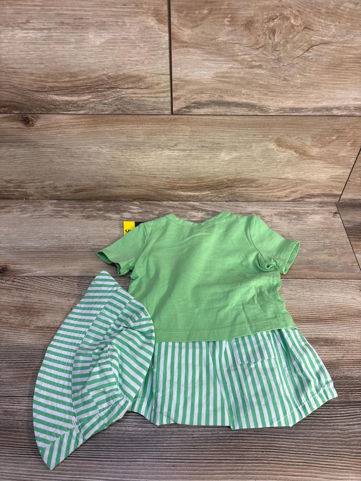 Front view of Baby Gap 3pc frog outfit set showcasing green T-shirt, striped shorts, and bucket hat on wood floor