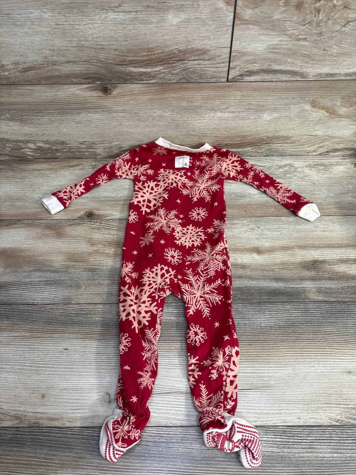 Red baby footed pajamas with snowflake print, perfect for holiday nights and cozy sleep.