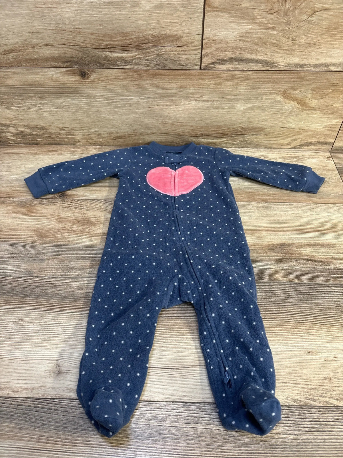 Front view of Carter’s polka dot blanket sleeper, size 9m, showcasing a pink heart and 2-way zipper on a wood background