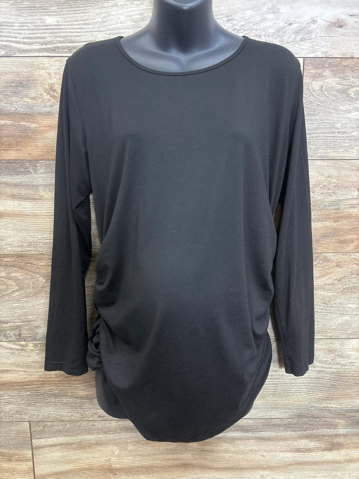 Front view of black Ekouaer maternity long-sleeve shirt with side ruching, on mannequin against wood background