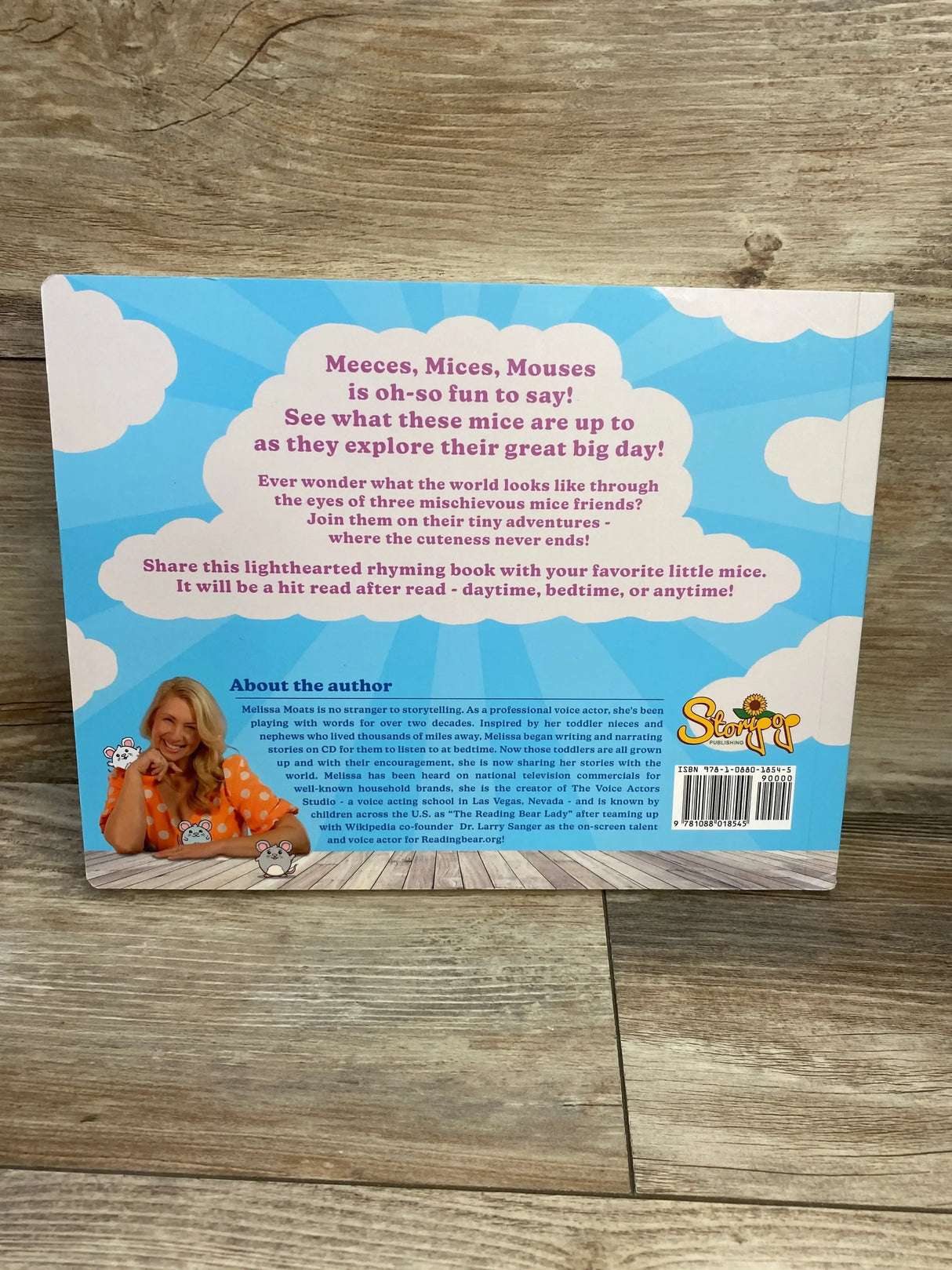 Back cover of Meeces, Mices, Mouses board book with headline "Meeces, Mices, Mouses is oh-so fun to say", purple rhyming blurb and author photo on a blue cloud background