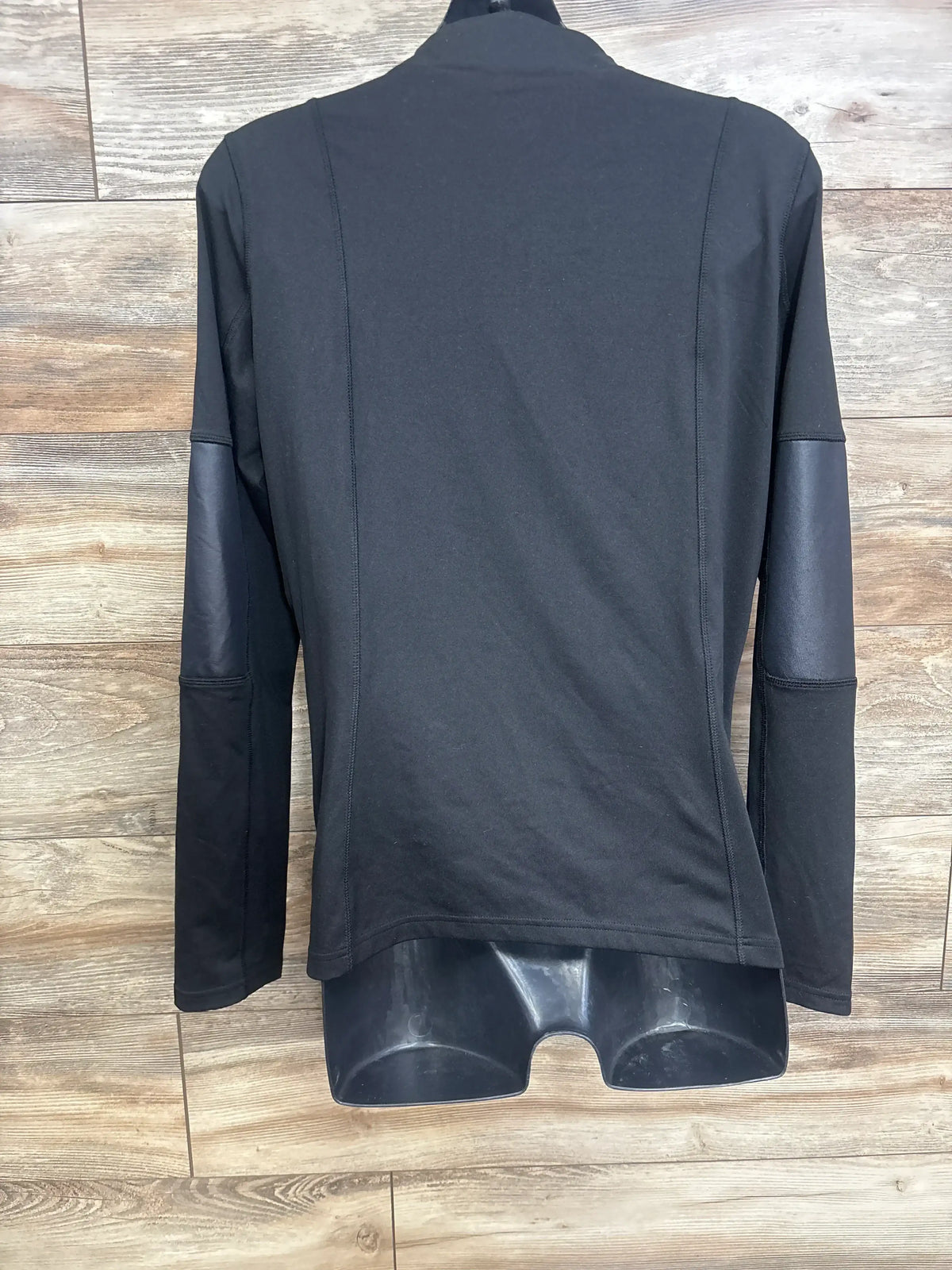 Back view of Isabel Maternity Active Side Zip Jacket in black, size XL, showing long sleeves on a mannequin over a wood-look floor