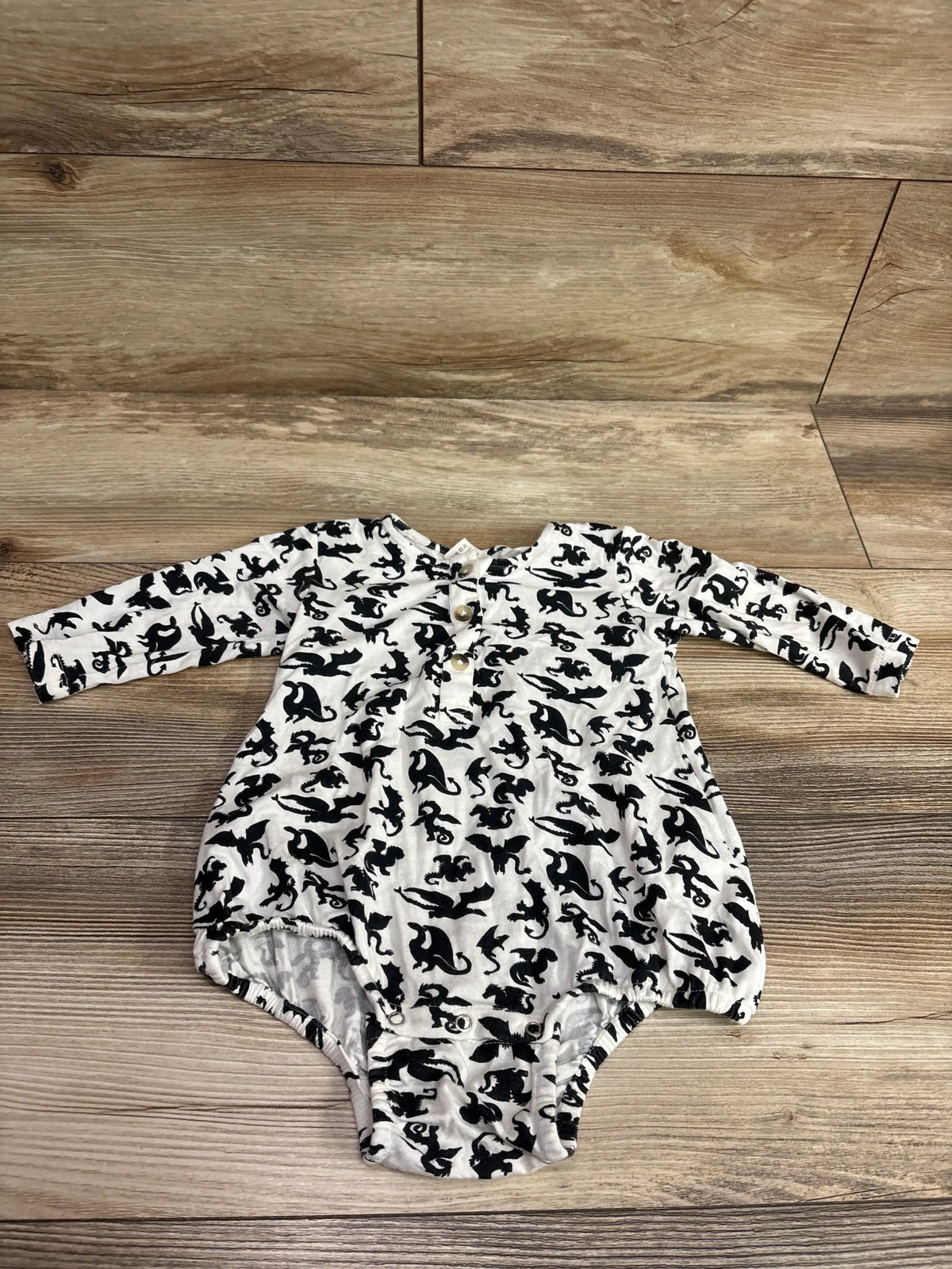 White Kate Quinn bamboo henley creeper for infants with black dragon print