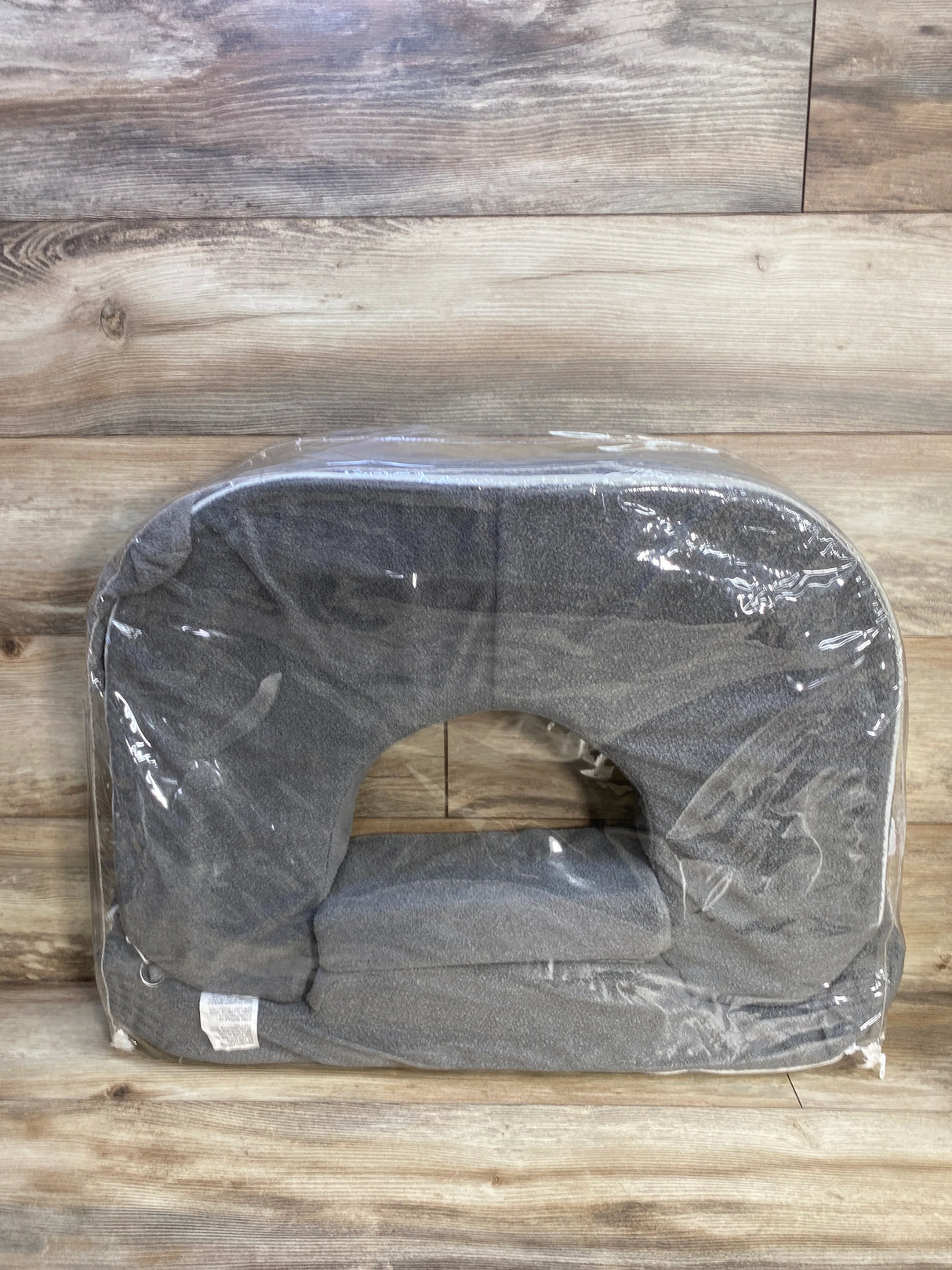 Front view of My Brest Friend twin nursing pillow in evening gray with U shaped cutout and lumbar support on wood background