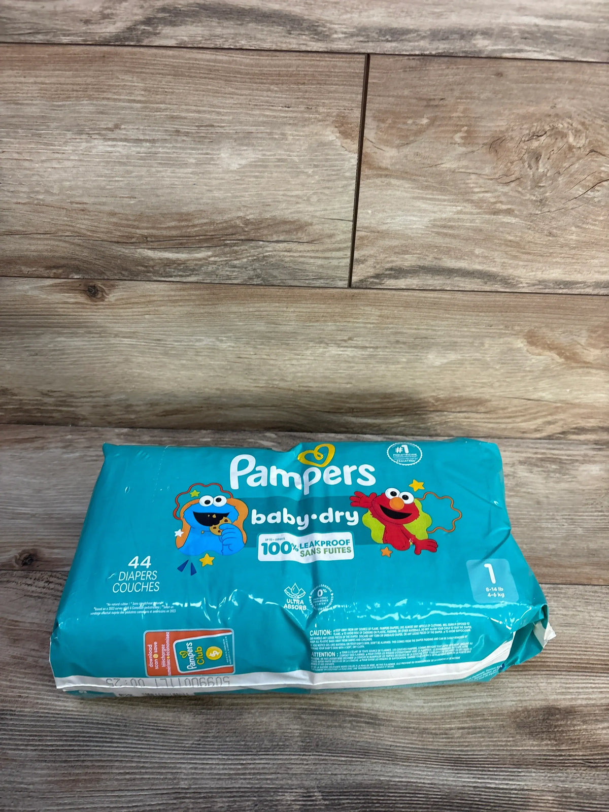 Front view of NEW Pampers Baby Dry Diapers Size 1 44ct package showing Sesame Street characters and leakproof protection
