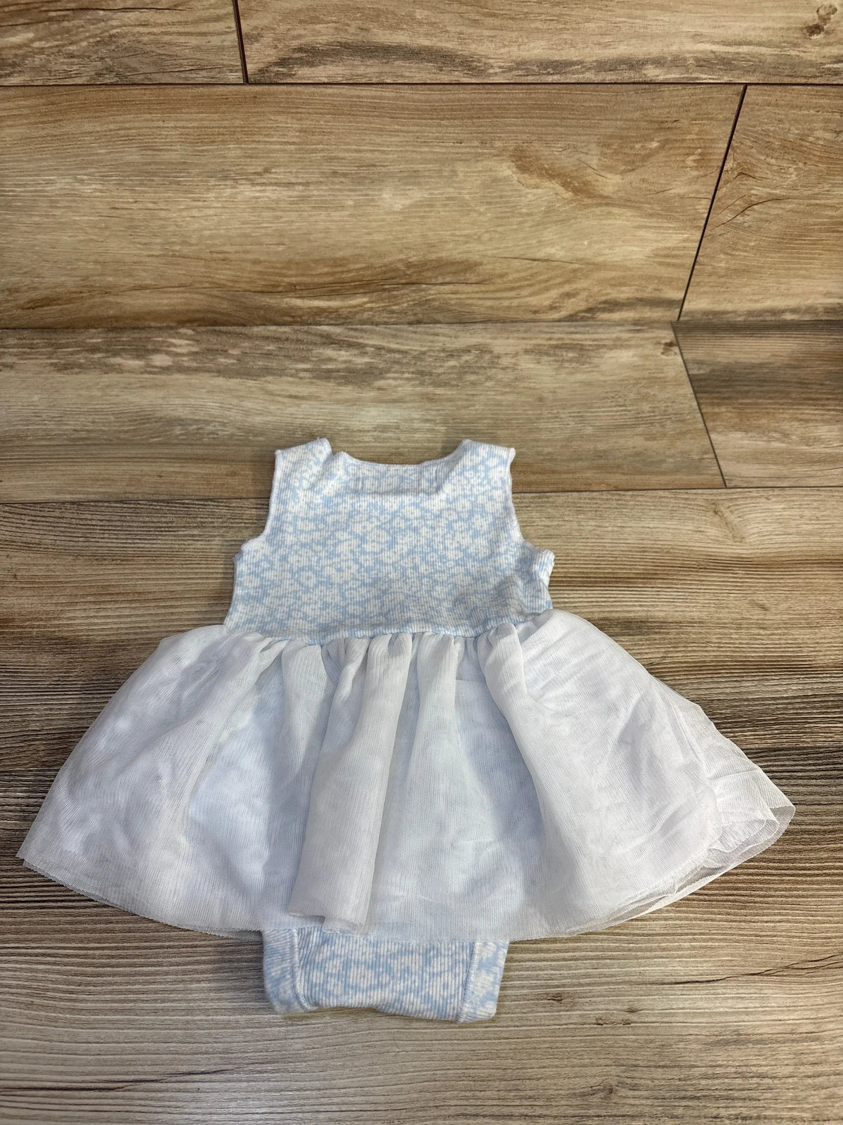 Old Navy ribbed blue floral baby bodysuit dress with white tulle skirt on wood background
