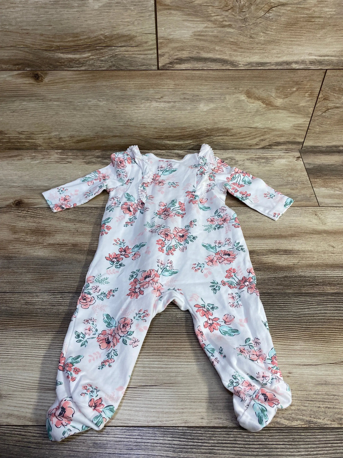 White Me n Mommy To Be baby sleeper with pink and red floral print on a wood background