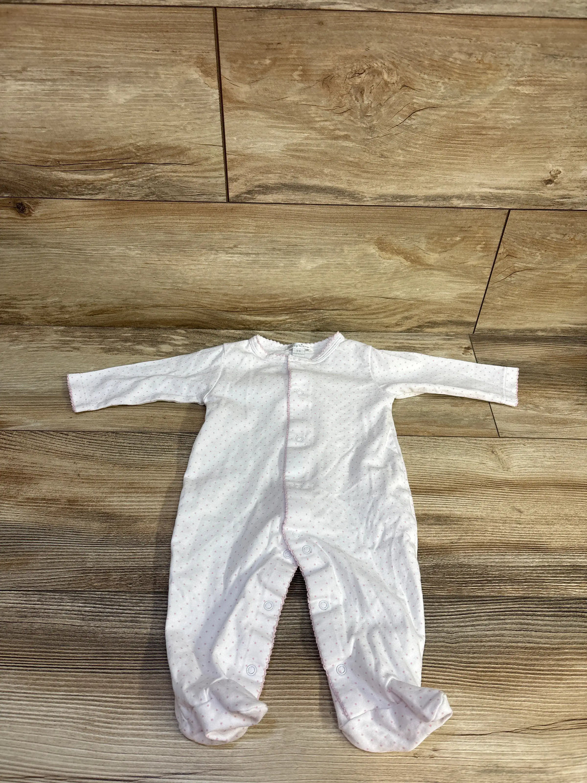 Front view of white Kissy Kissy Polka Dot Snap Sleeper with long sleeves, footed legs, and snap closures