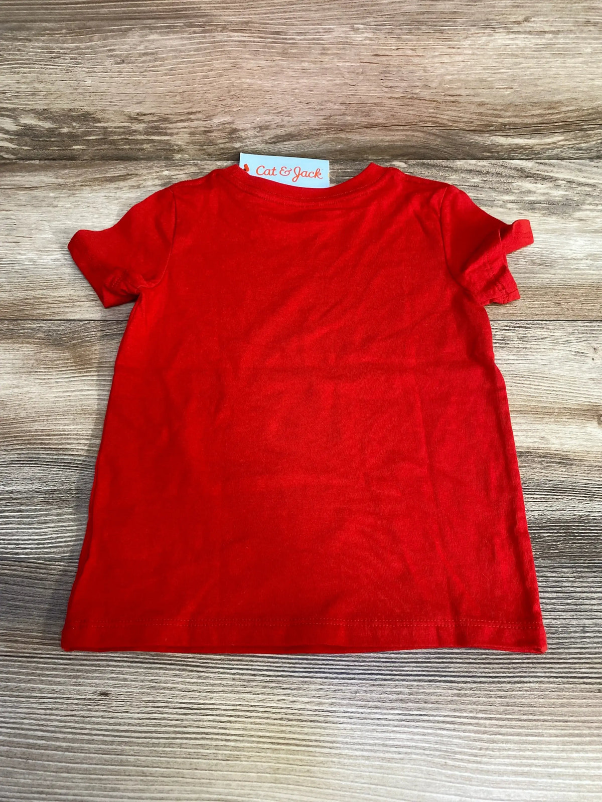 Back view of Cat and Jack red toddler T-shirt (2T) showcasing plain back and crew neck with wood plank background