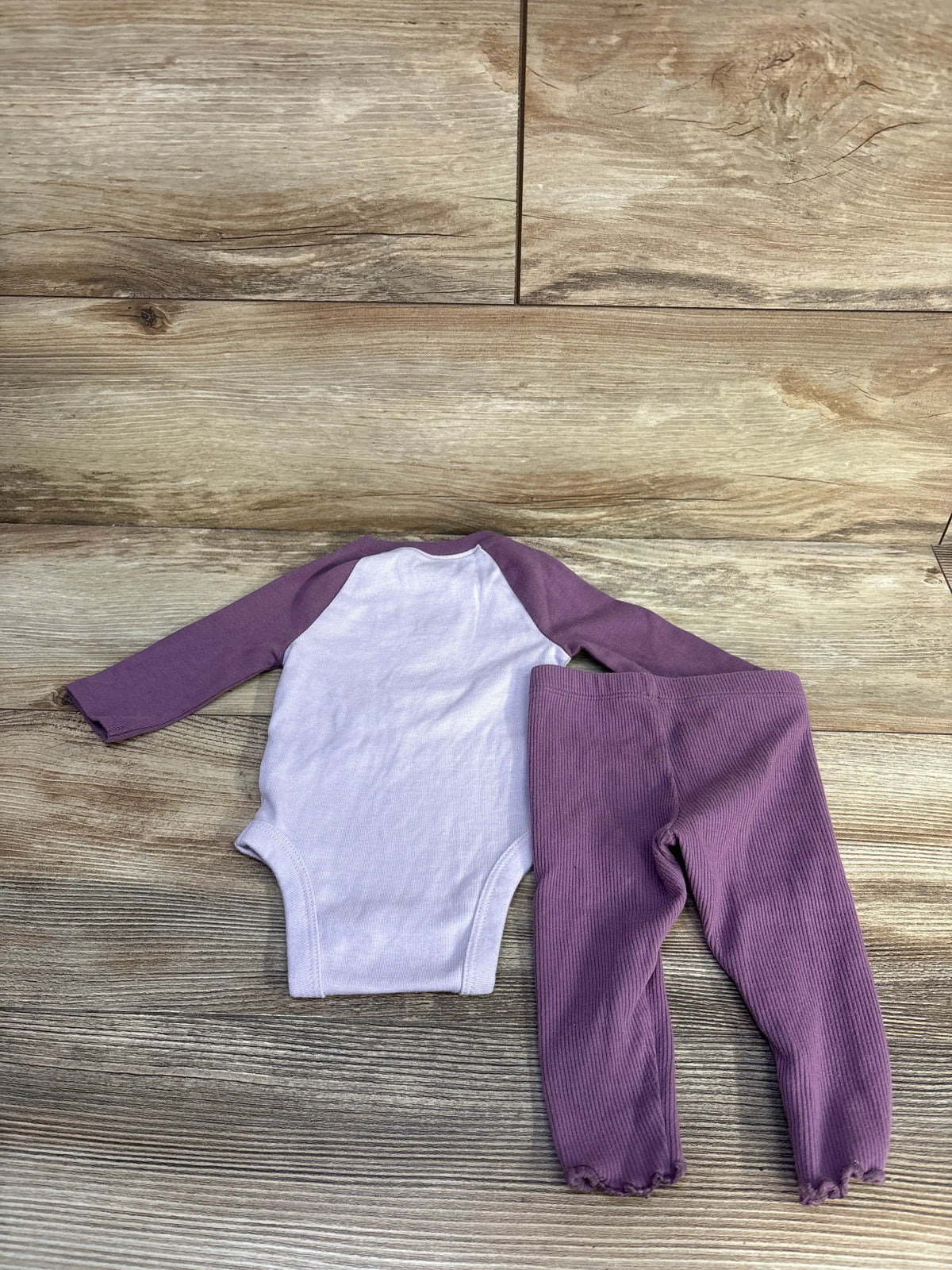 Front view of Jumping Beans two-piece bodysuit and bottoms set with lavender bodysuit, raglan sleeves, and ribbed bottoms